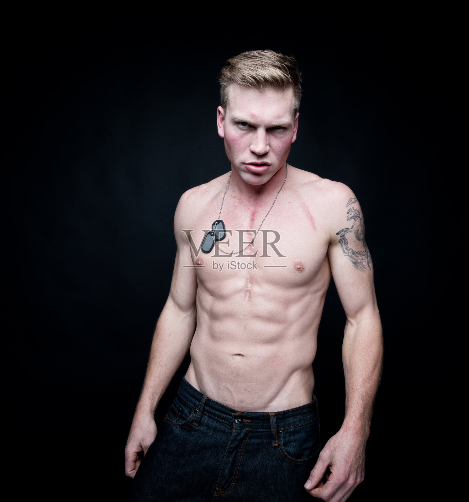 英俊的赤膊男子穿着狗牌照片摄影图片