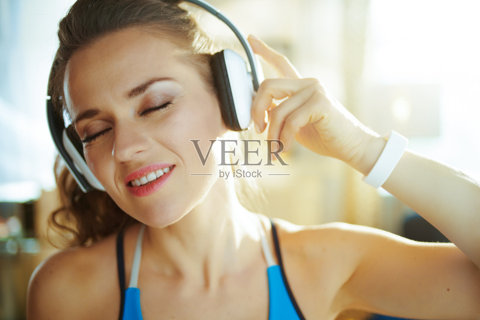 快乐的年轻女运动员听音乐耳机照片摄影图片