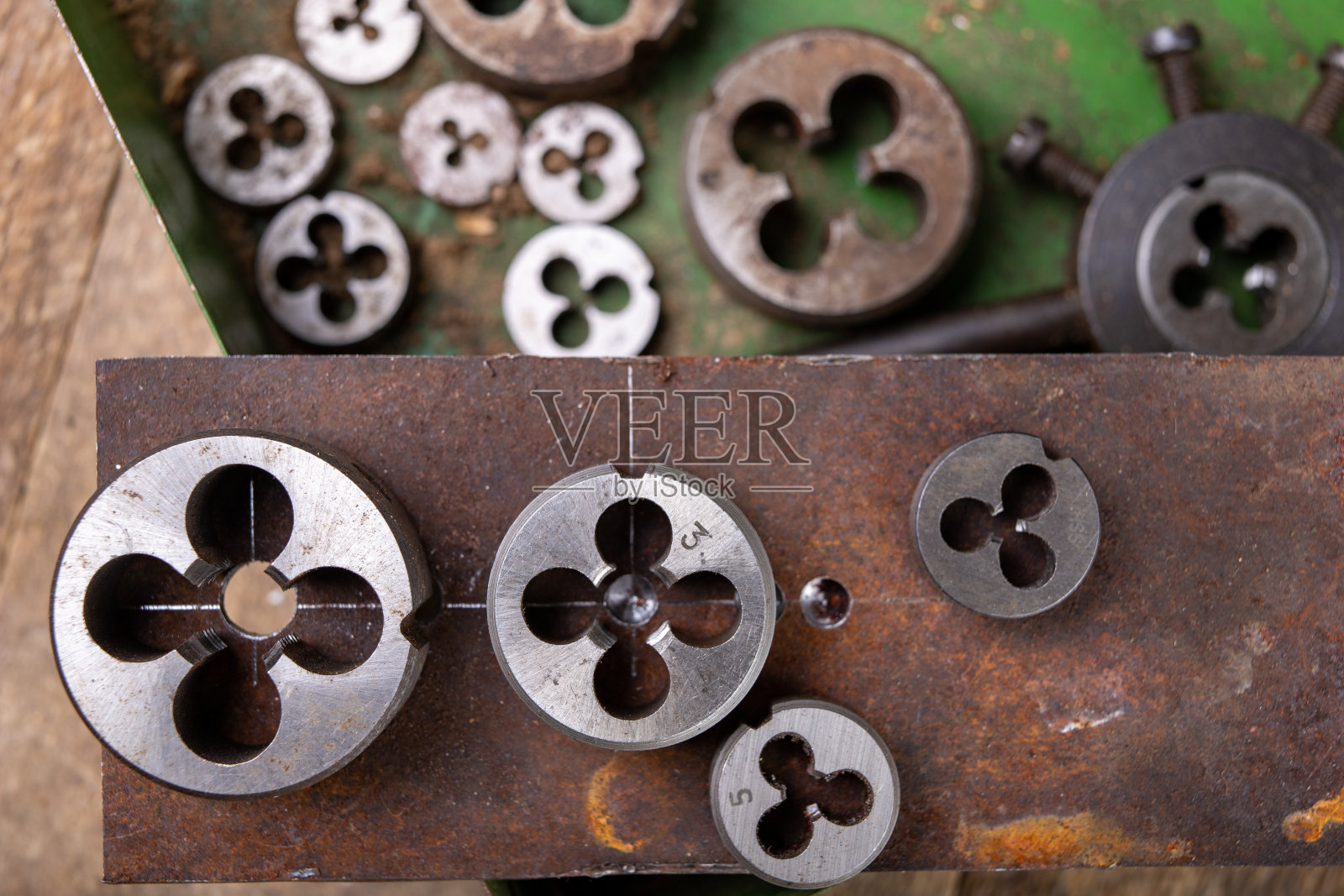 手动螺纹切割金属。小工锁匠配件的家庭车间。黑暗的使用照片摄影图片