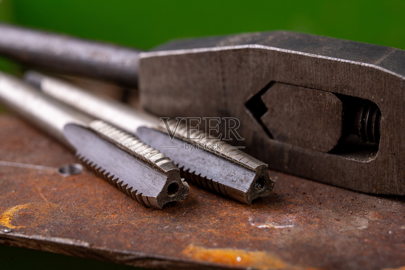 手动螺纹切割金属。小工锁匠配件的家庭车间。黑暗的使用照片摄影图片