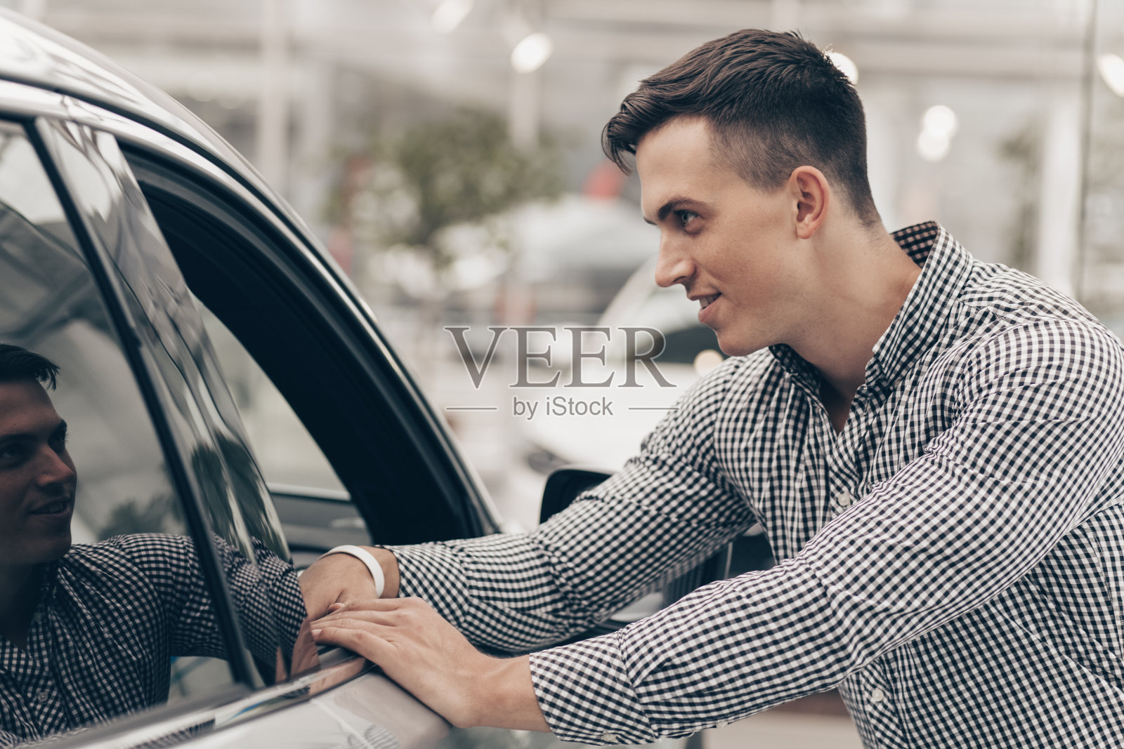 年轻人在汽车经销店买车照片摄影图片