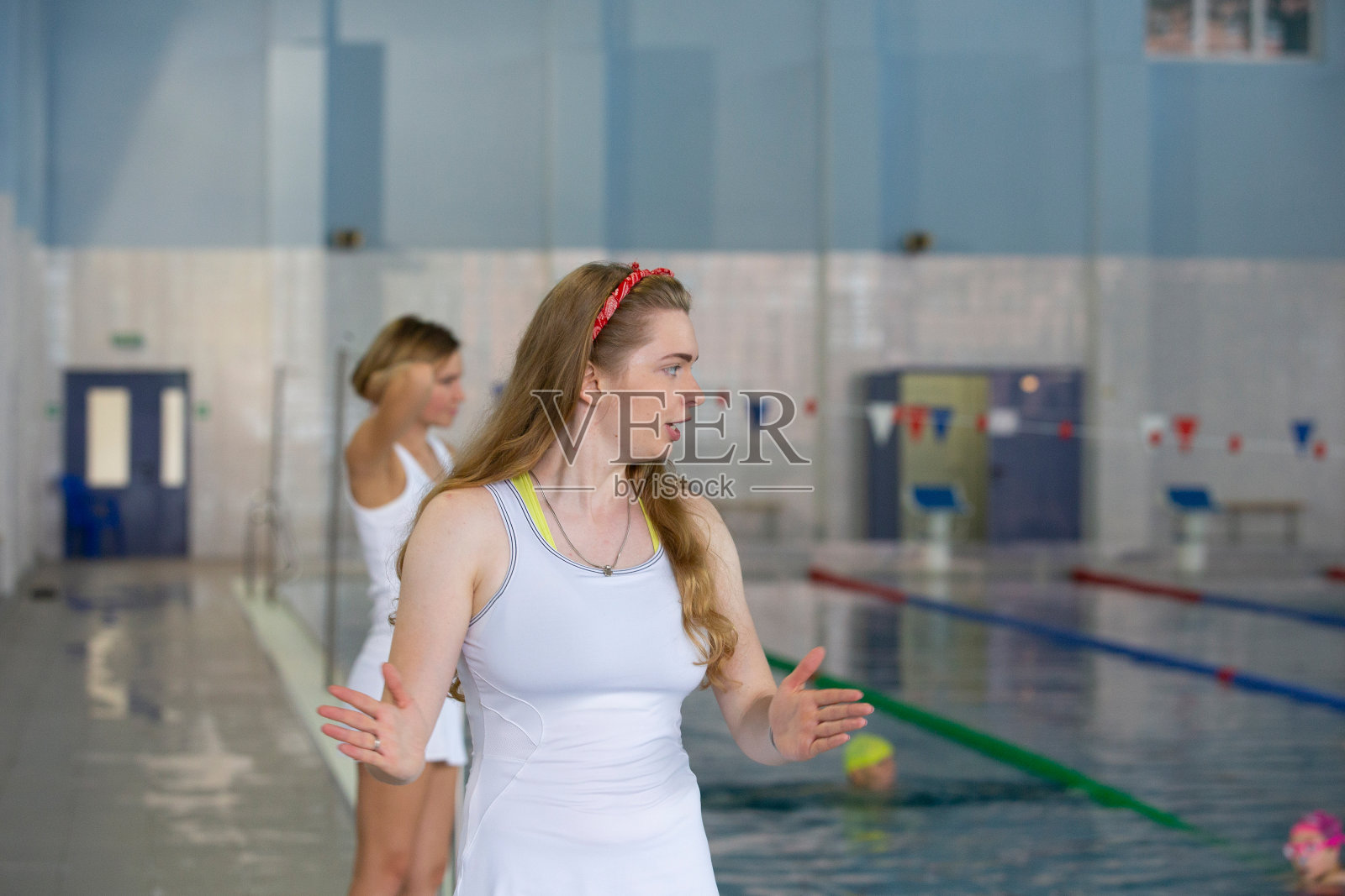 在休闲中心,漂亮的游泳教练对着镜头微笑照片摄影图片