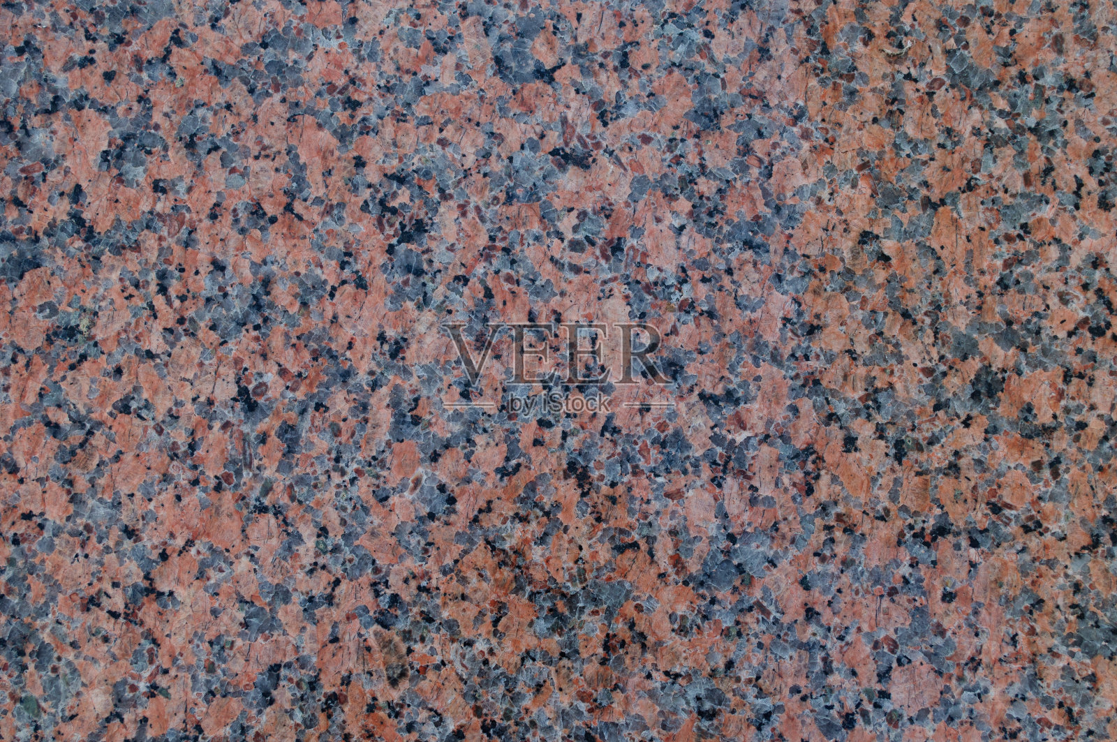 带有灰色和黑色斑点的棕色天然石材。照片摄影图片