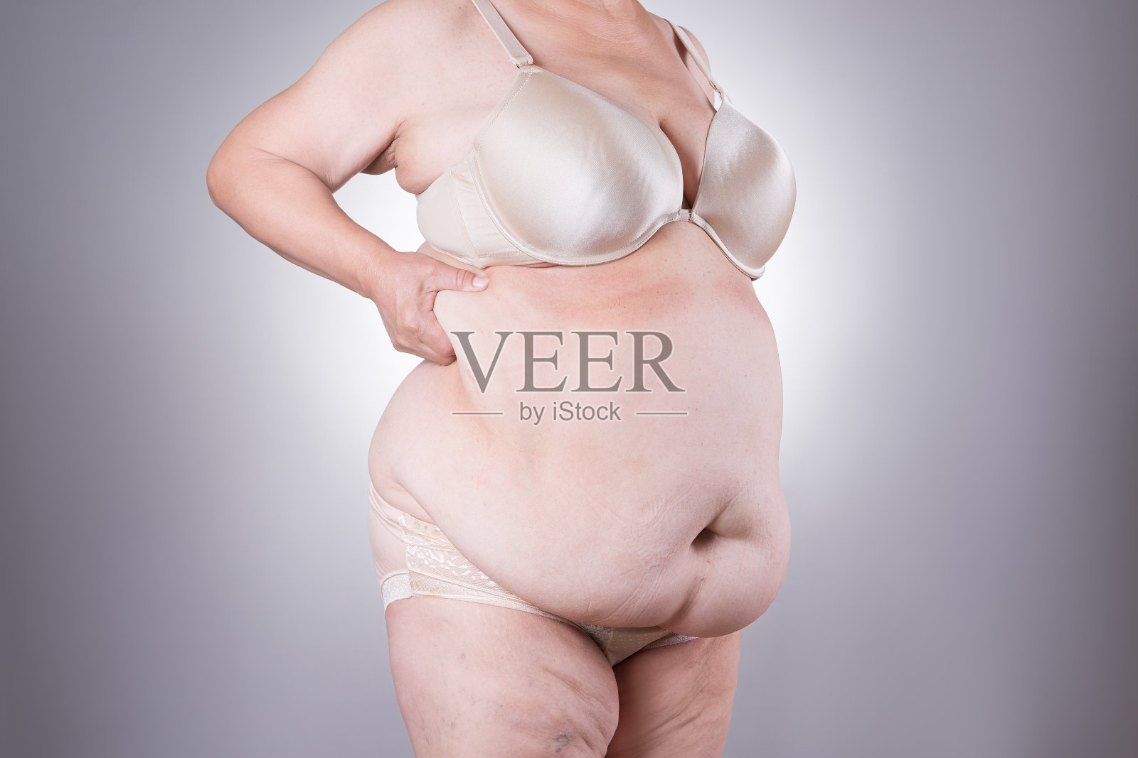 腹部整形,腹部松弛的皮肤,整形手术的概念照片摄影图片