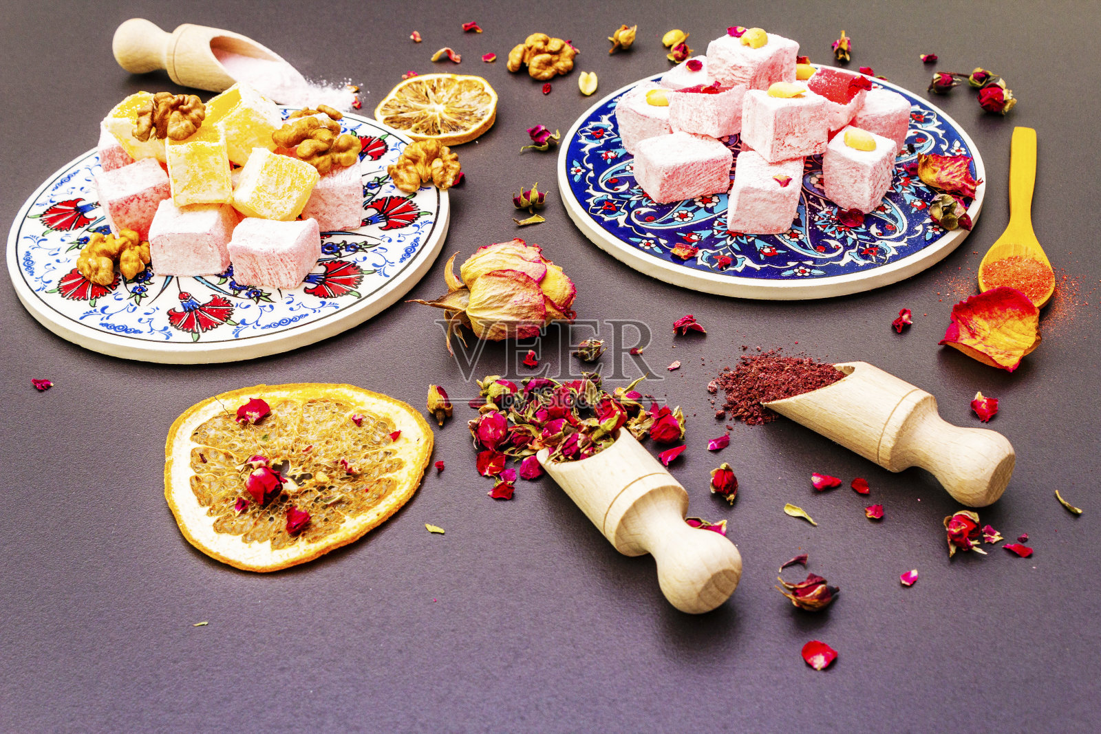 东部的糖果。传统的土耳其喜悦与玫瑰和柑橘在陶瓷上具有典型的民间图案照片摄影图片