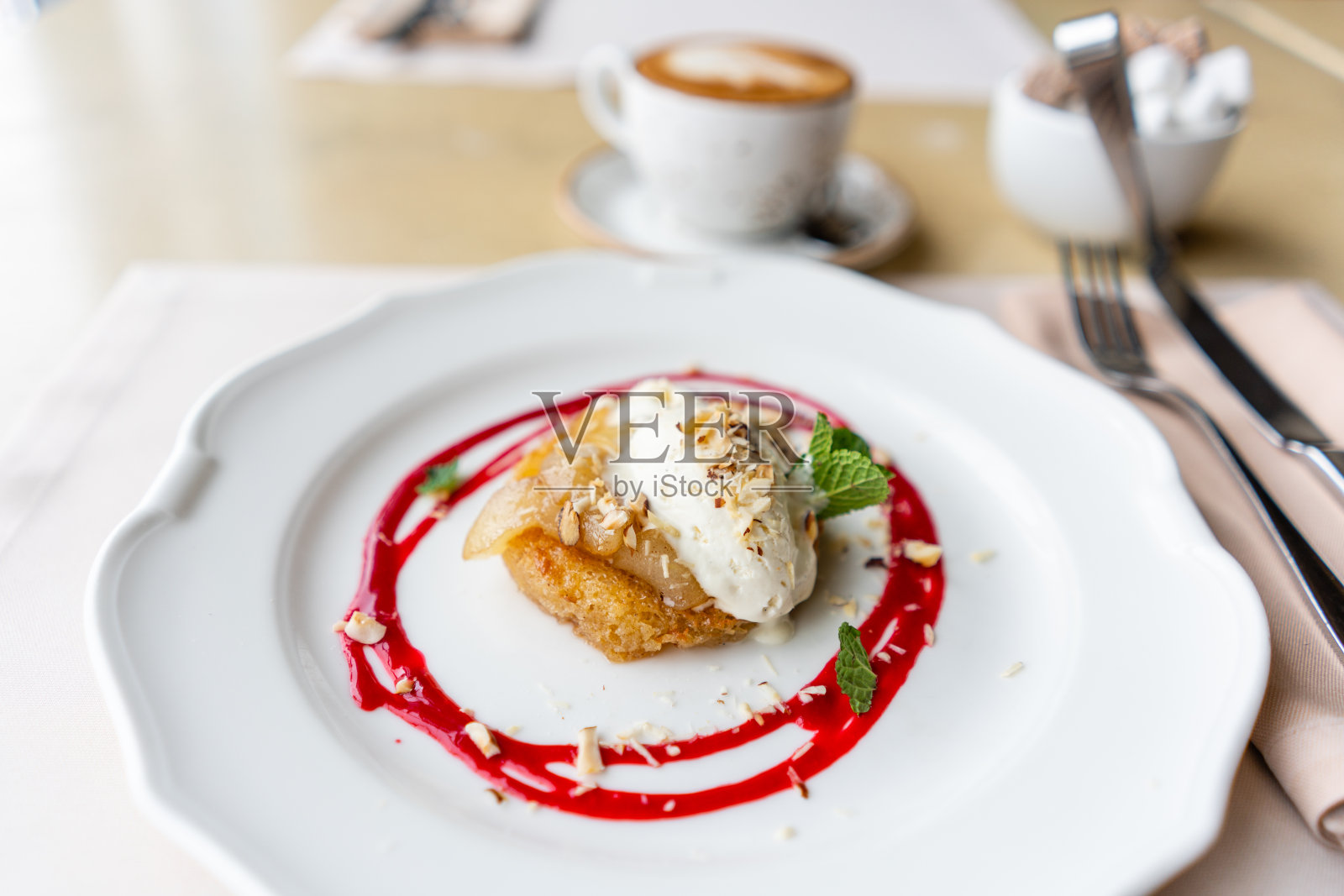 法式吐司奶油蛋糕配香草冰淇淋,梨,坚果,薄荷叶和红莓酱。轻松的早餐,新鲜温暖的糕点和芳香的卡布奇诺咖啡照片摄影图片