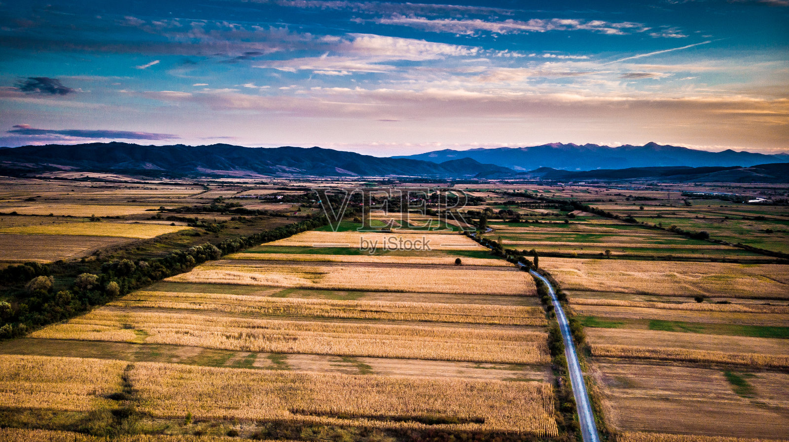 鸟瞰图的乡村道路和农地在日落照片摄影图片