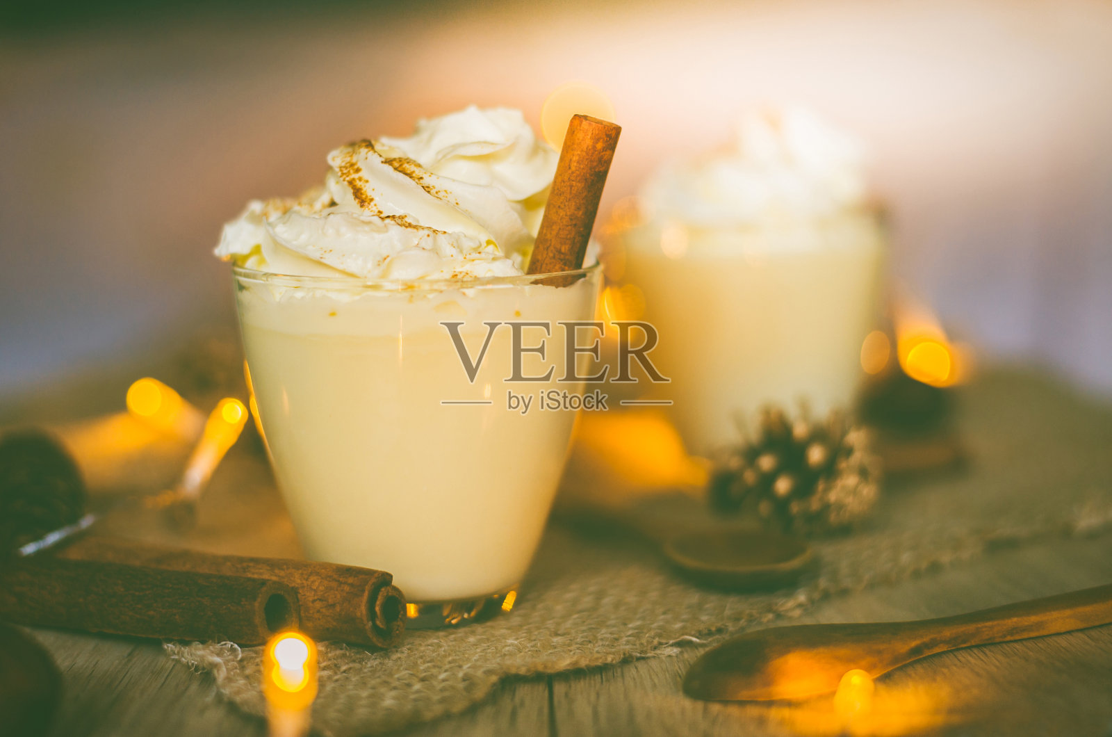 圣诞节和冬季的时候,木桌上放着蛋奶酒和肉桂。Copyspace包括在内。照片摄影图片