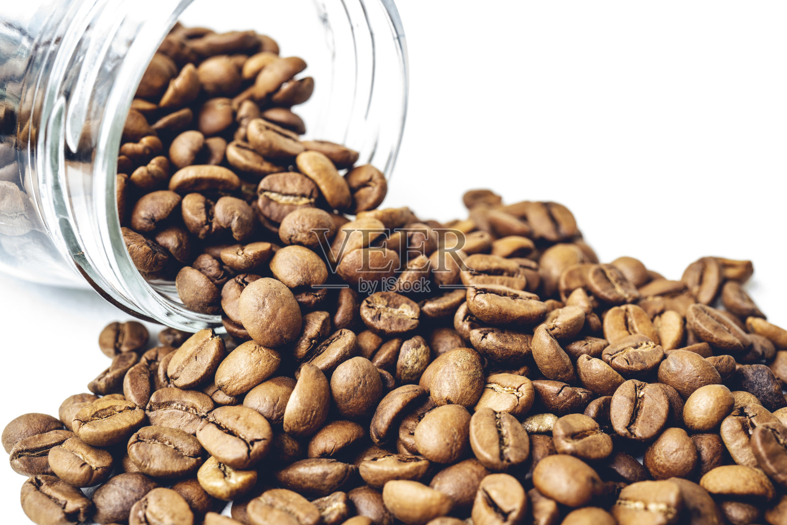 从玻璃罐中滚出的烘焙咖啡豆照片摄影图片