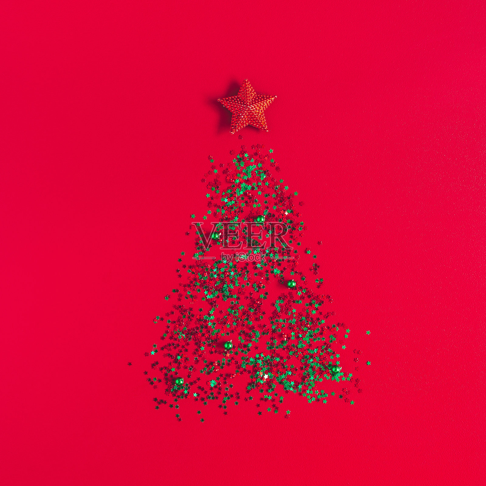 圣诞组成。红色背景上的五彩纸屑做成的圣诞树。平躺,俯视图,正方形照片摄影图片