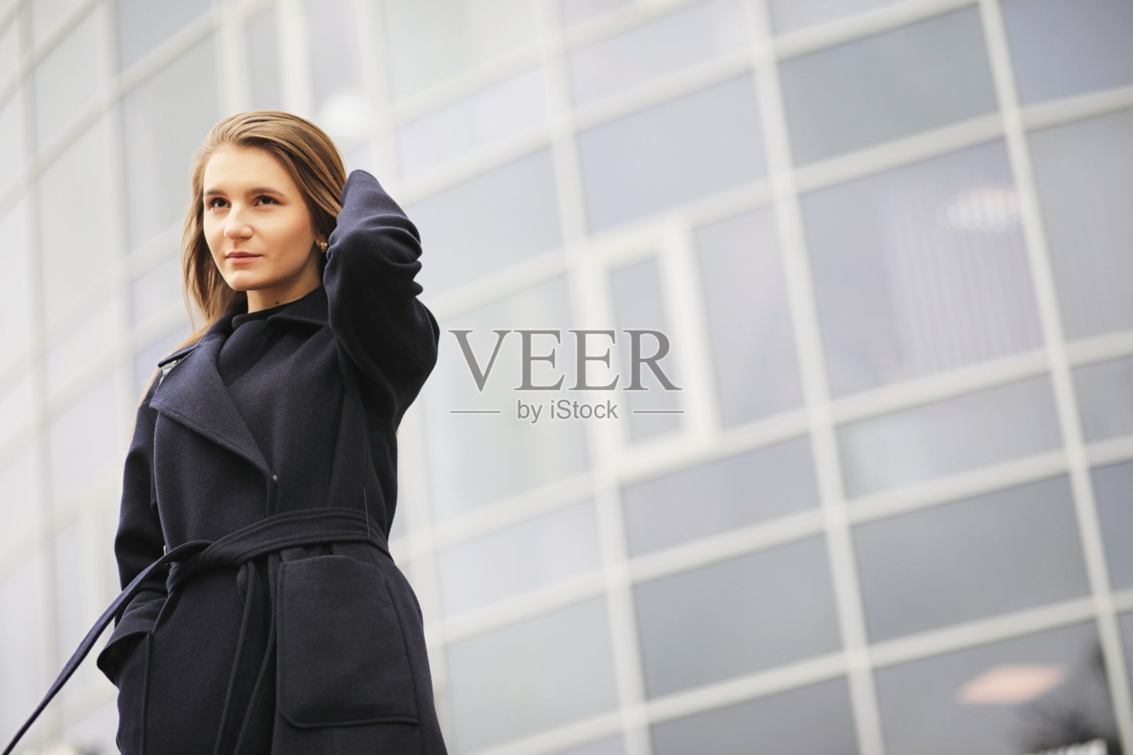 在商业区穿着外套的漂亮女孩照片摄影图片