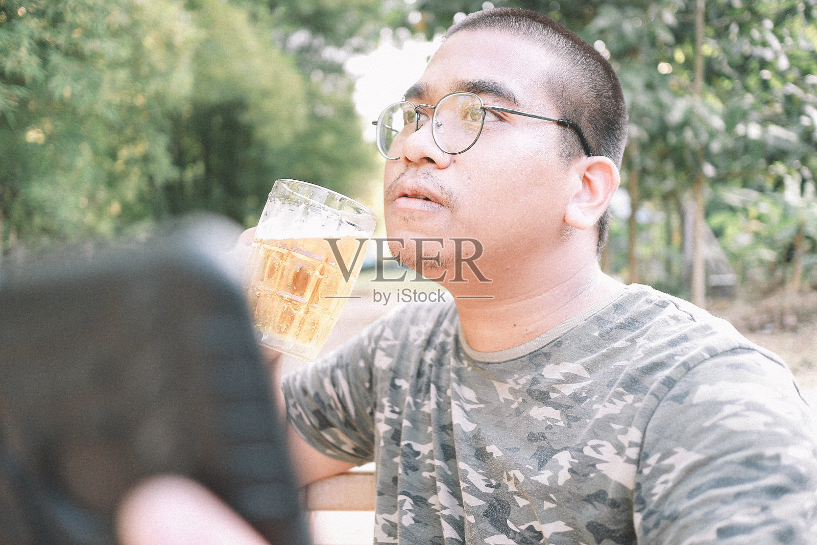 棕色皮肤的男人快乐地喝着啤酒照片摄影图片