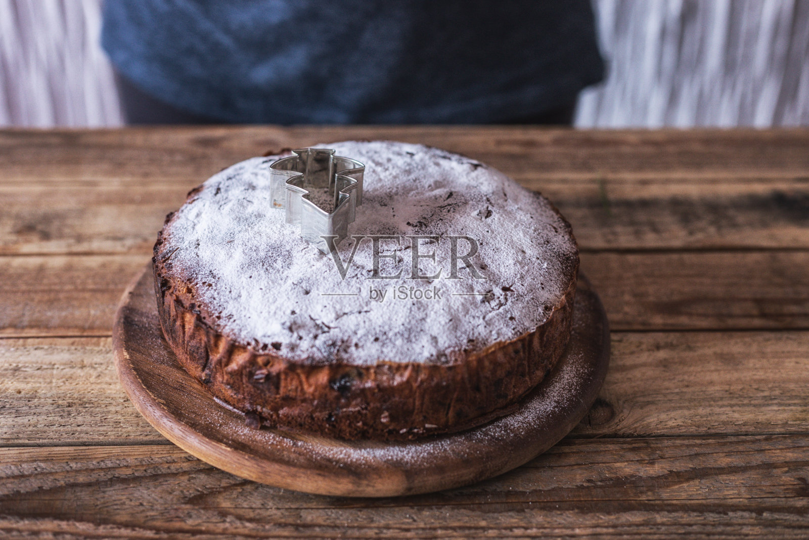 厨师用巧克力屑和松树形状的模具装饰新鲜制作的圣诞饼干照片摄影图片