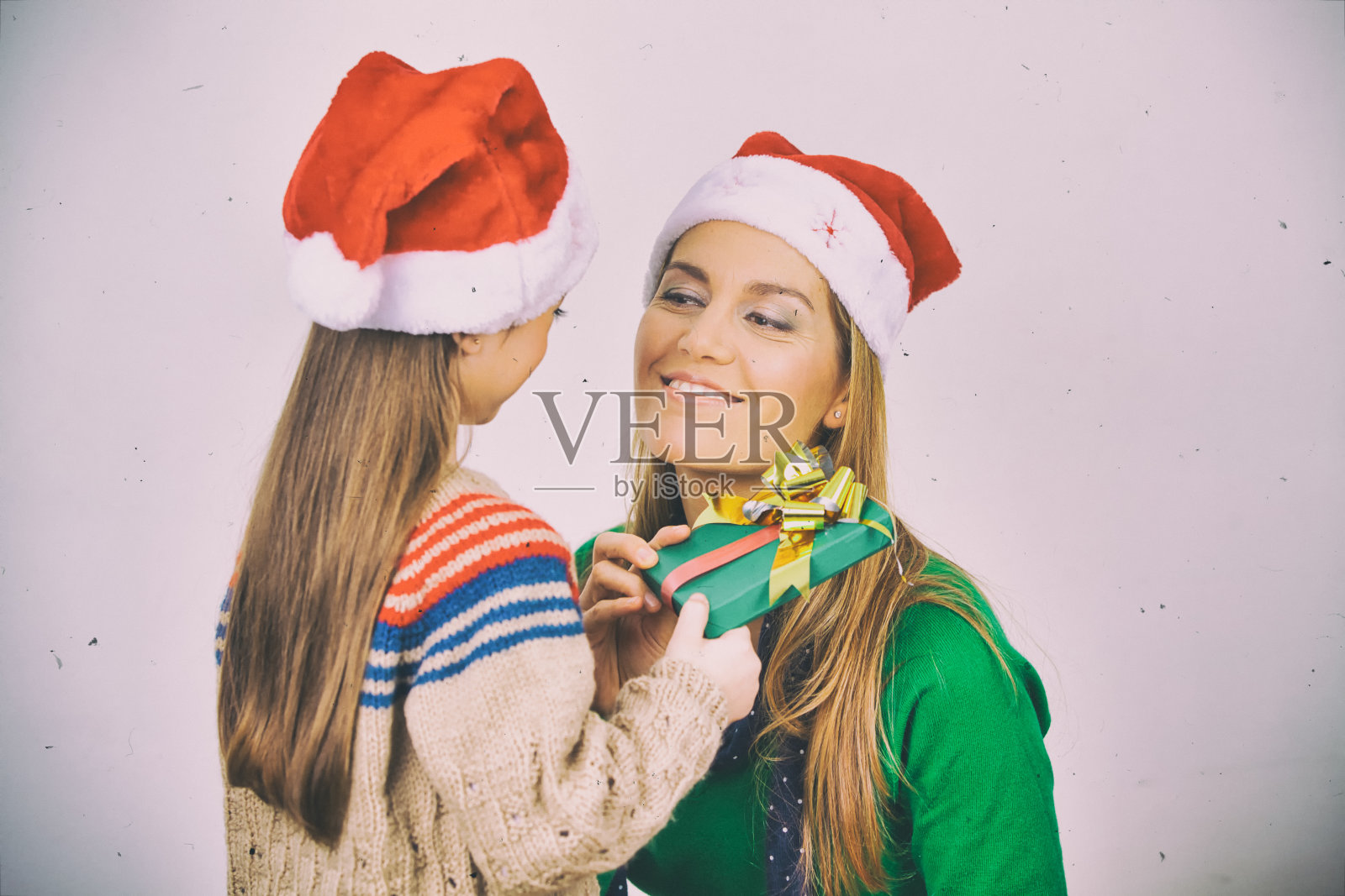 圣诞节的概念。温柔。妈妈和女儿交换圣诞礼物照片摄影图片