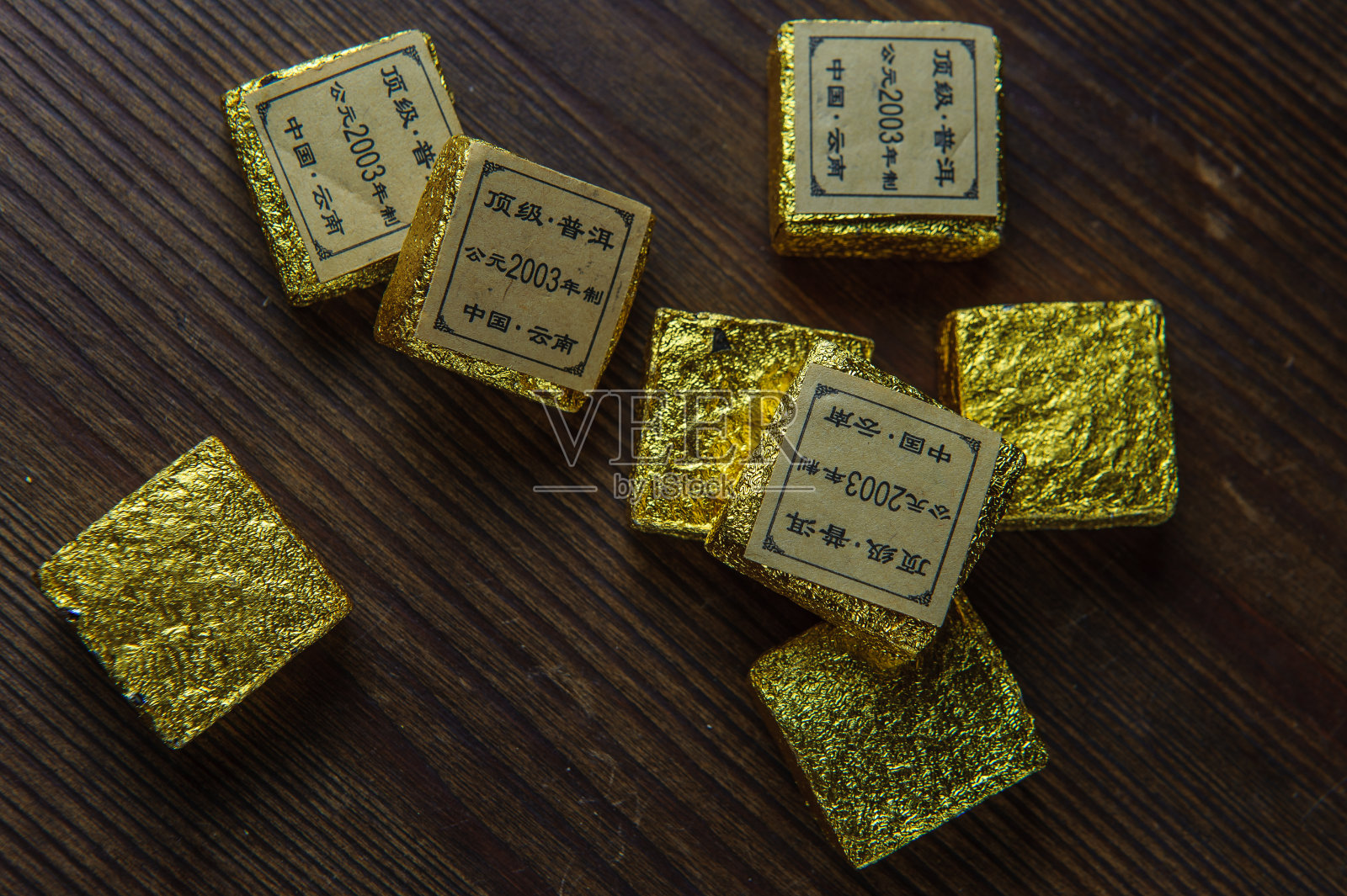 木桌上放着金包装的中国茶照片摄影图片