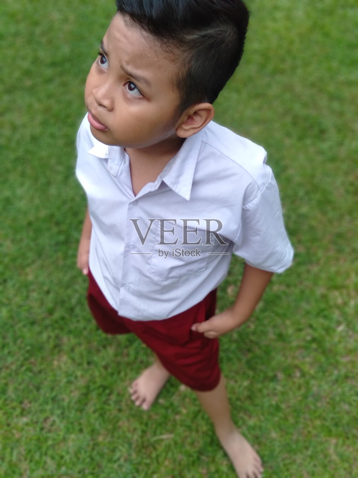 三个印尼兄弟放学后在一个安静的花园一起玩。照片摄影图片