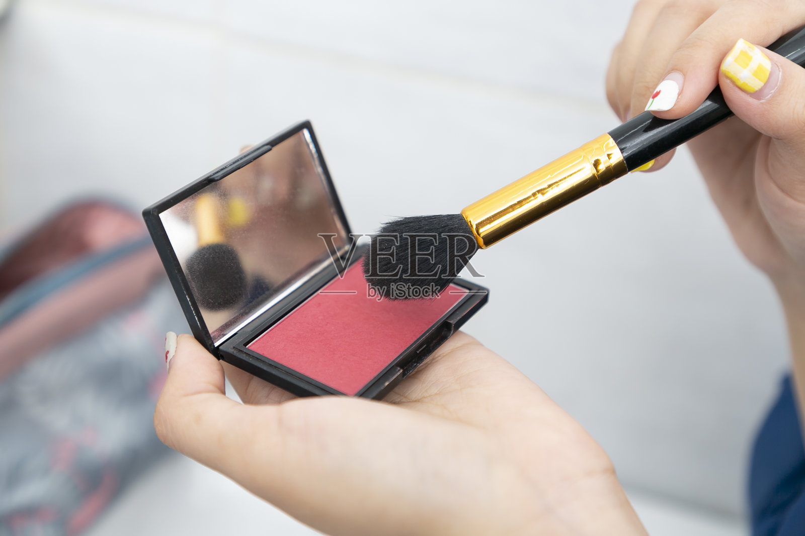 化妆师使用自然发刷涂抹化妆品。照片摄影图片