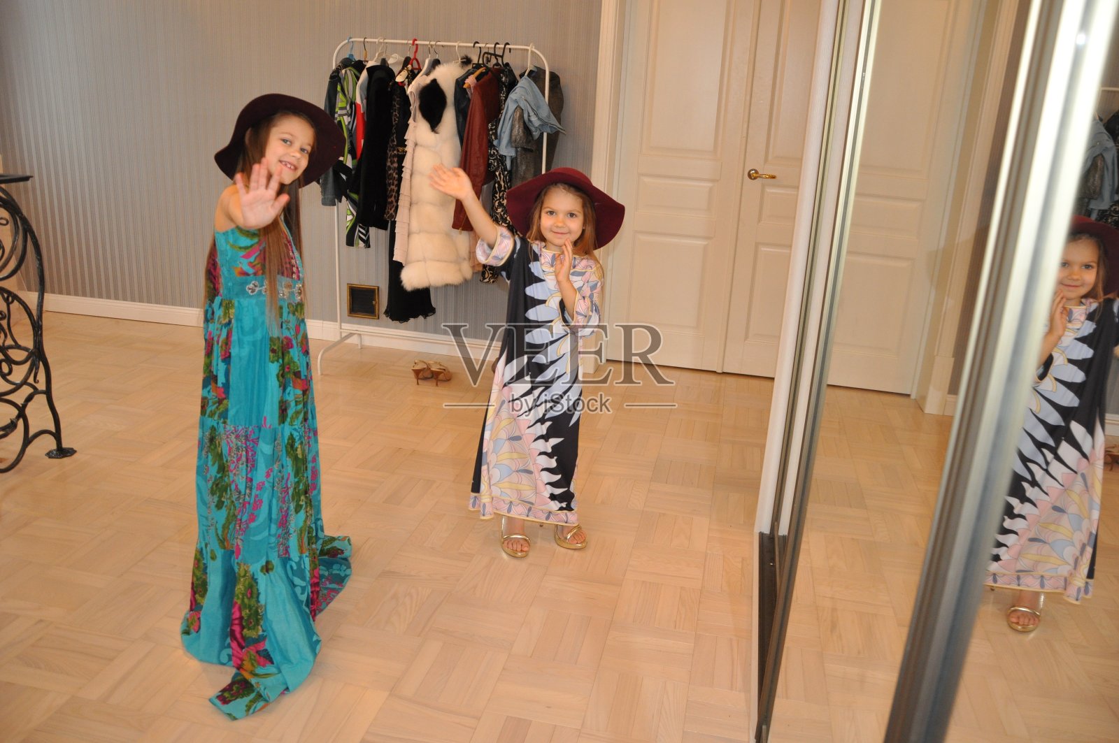 来自白俄罗斯的两姐妹穿上她们母亲的衣服,装扮自己。照片摄影图片