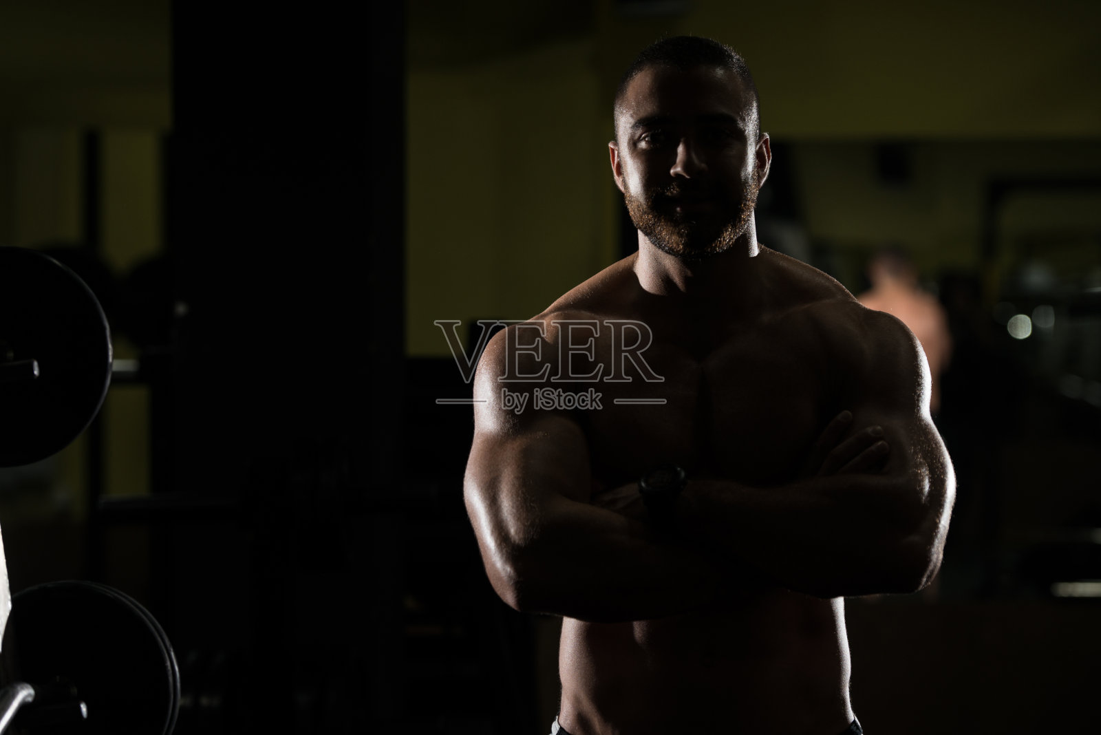 剪影健美者收缩肌肉照片摄影图片