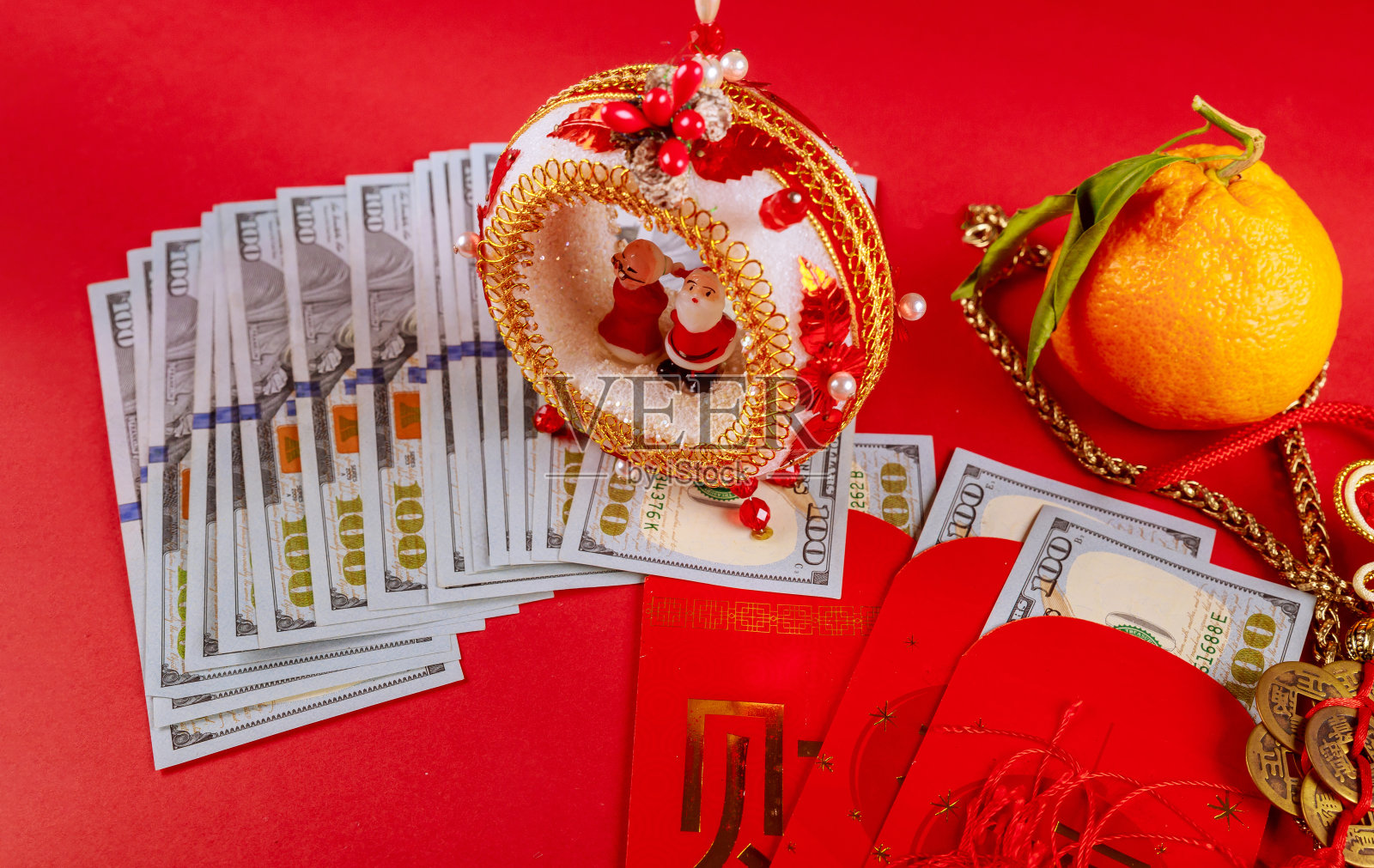 红包上的中国阴阳护身符、新年装饰、橘子和美元照片摄影图片