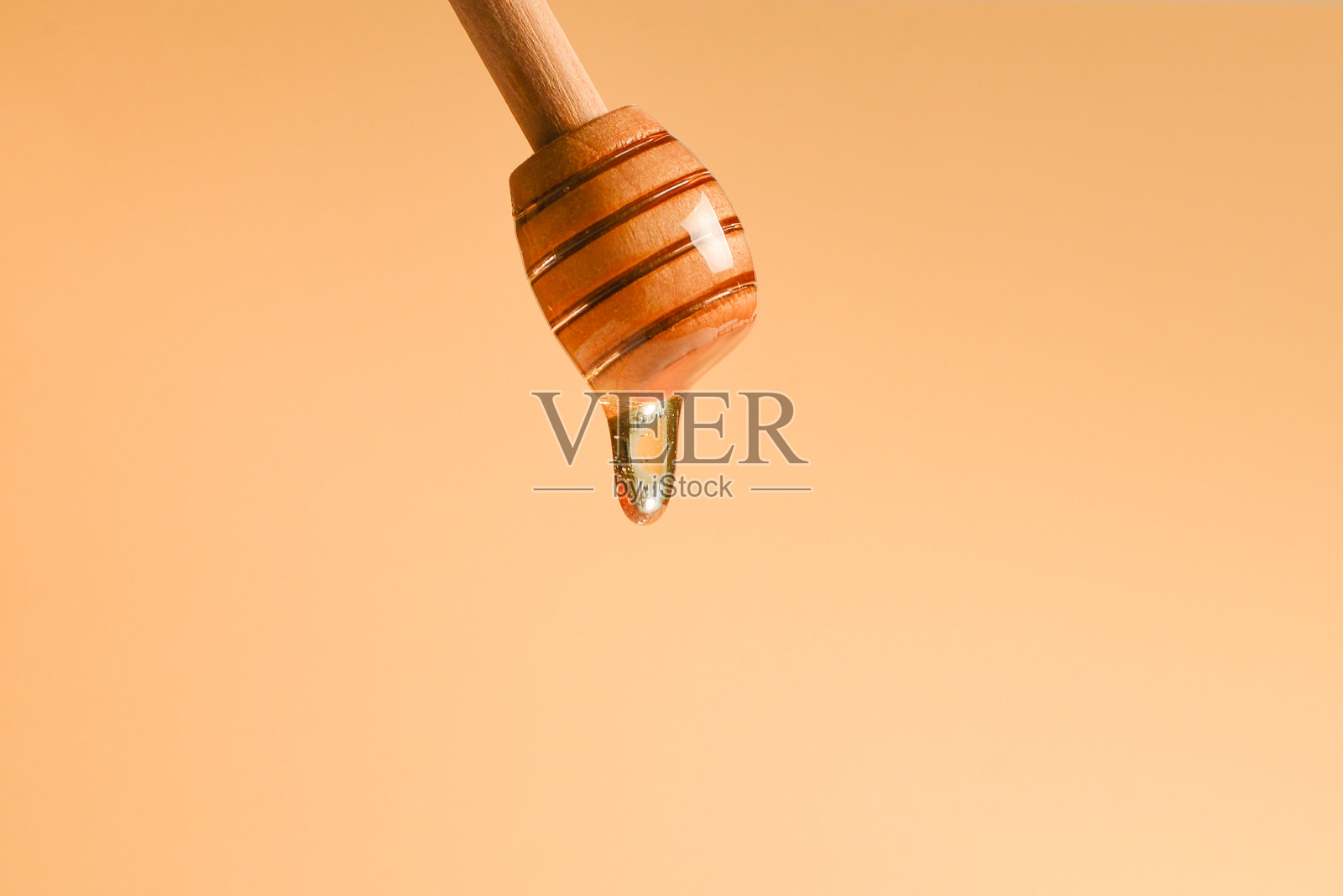 橘色背景上的浅斗蜂蜜。副本的空间。照片摄影图片