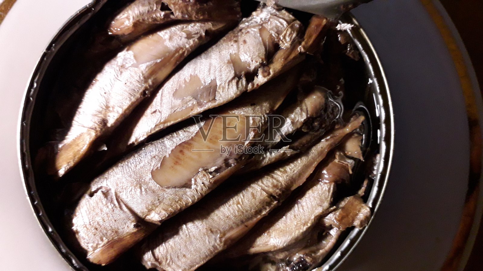 在锡罐中放入油中的鱼的质地照片摄影图片