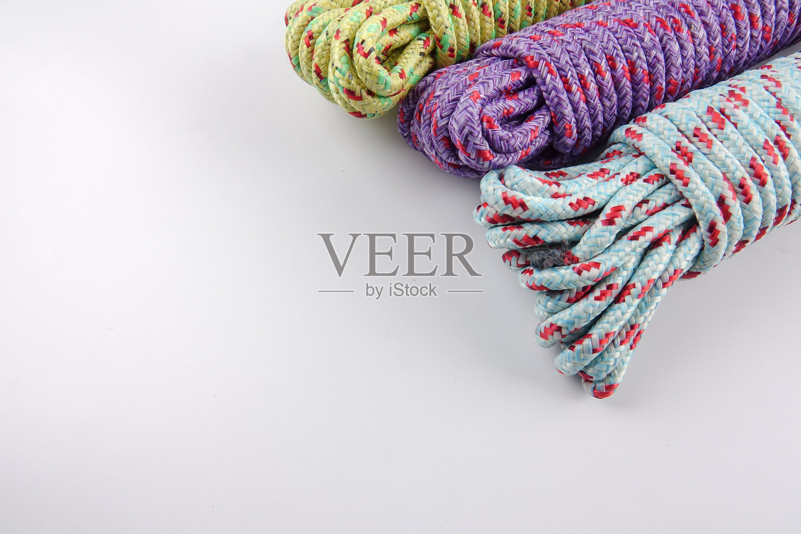 不同颜色的绳索孤立在白色背景上。照片摄影图片
