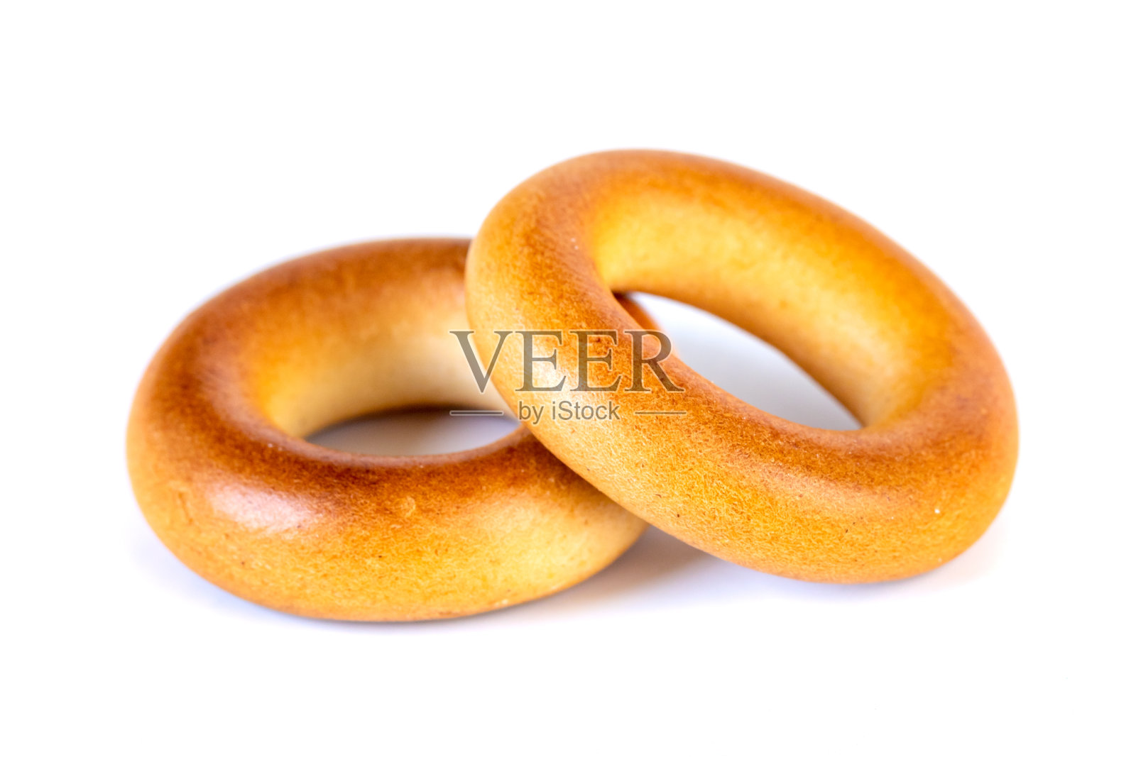 又小又干的百吉饼,白色背景下的小面包卷照片摄影图片