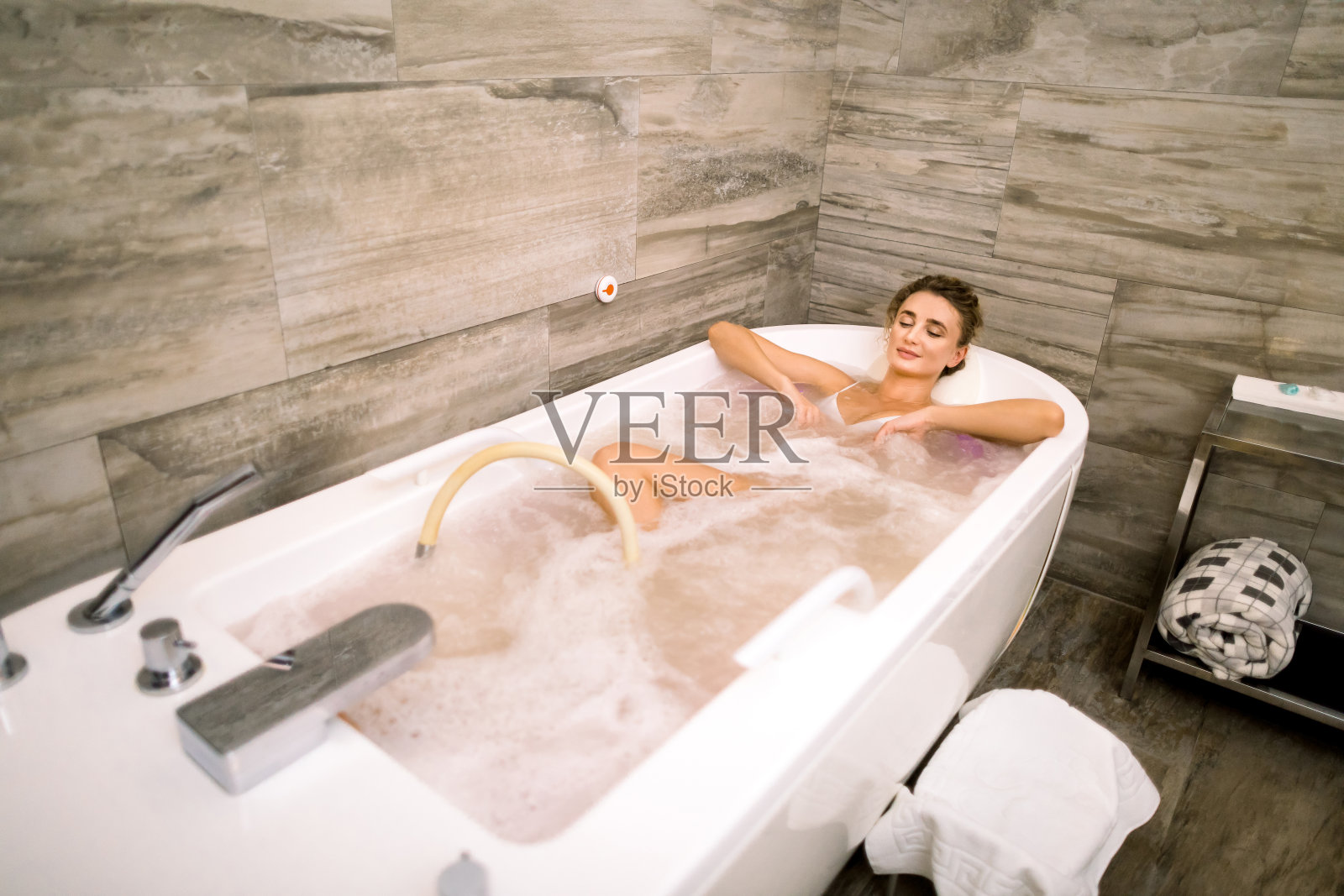 健康水疗:年轻白人女子在浴缸中享受水力按摩照片摄影图片