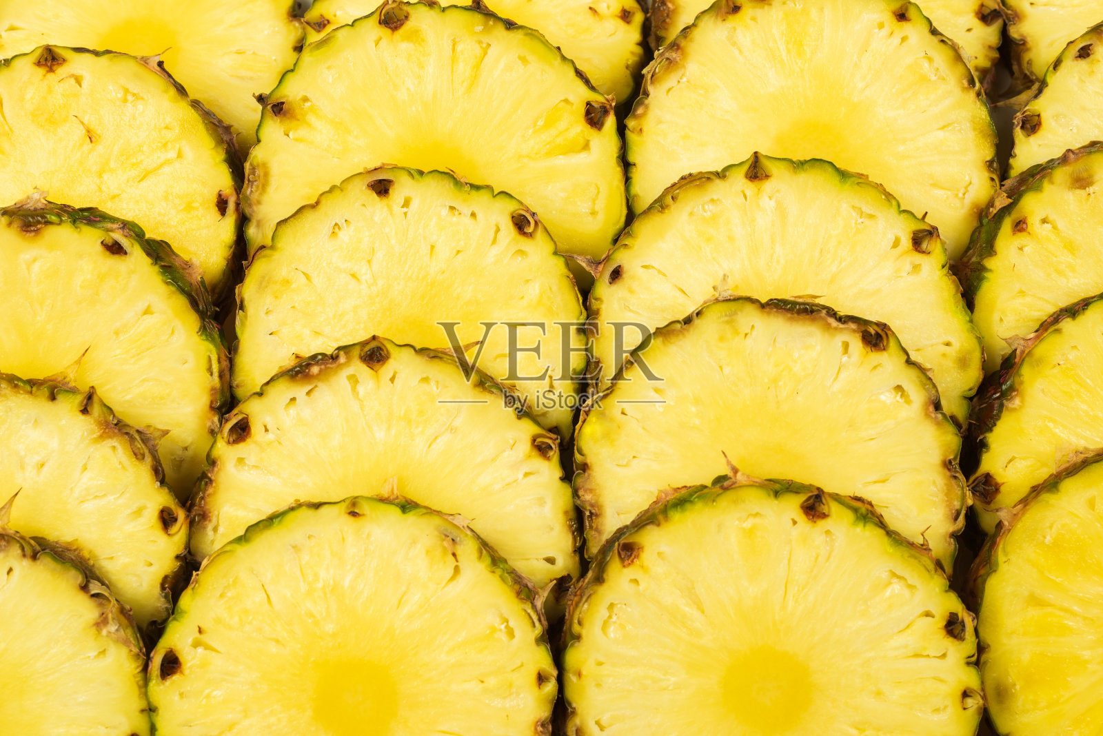 菠萝汁黄色切片背景。前视图。照片摄影图片