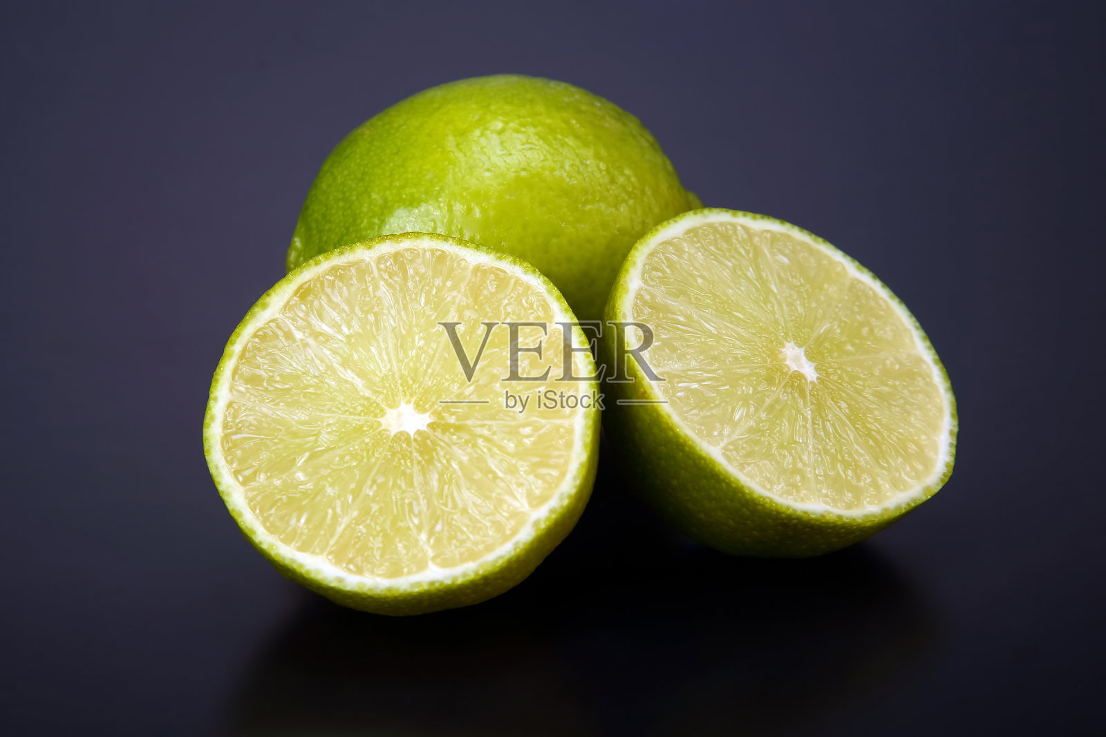 柑橘类水果。在灰色背景上把柠檬切成两半照片摄影图片