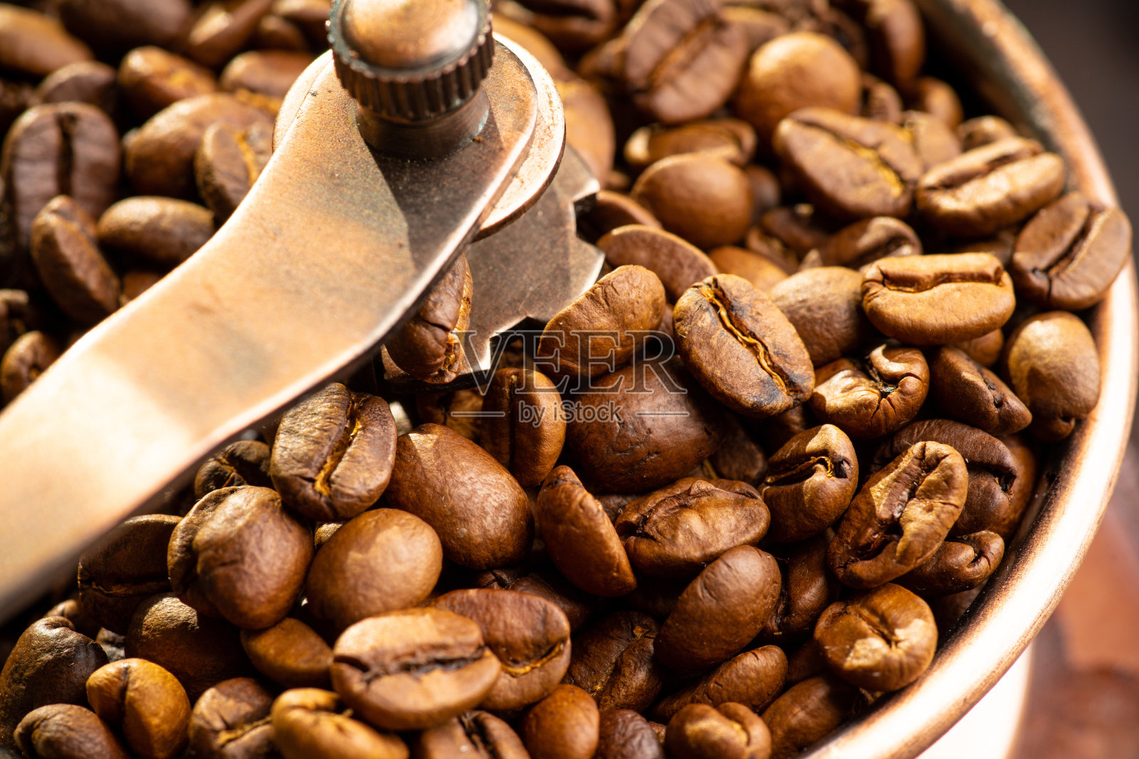 在质朴的木质背景上,磨咖啡豆照片摄影图片