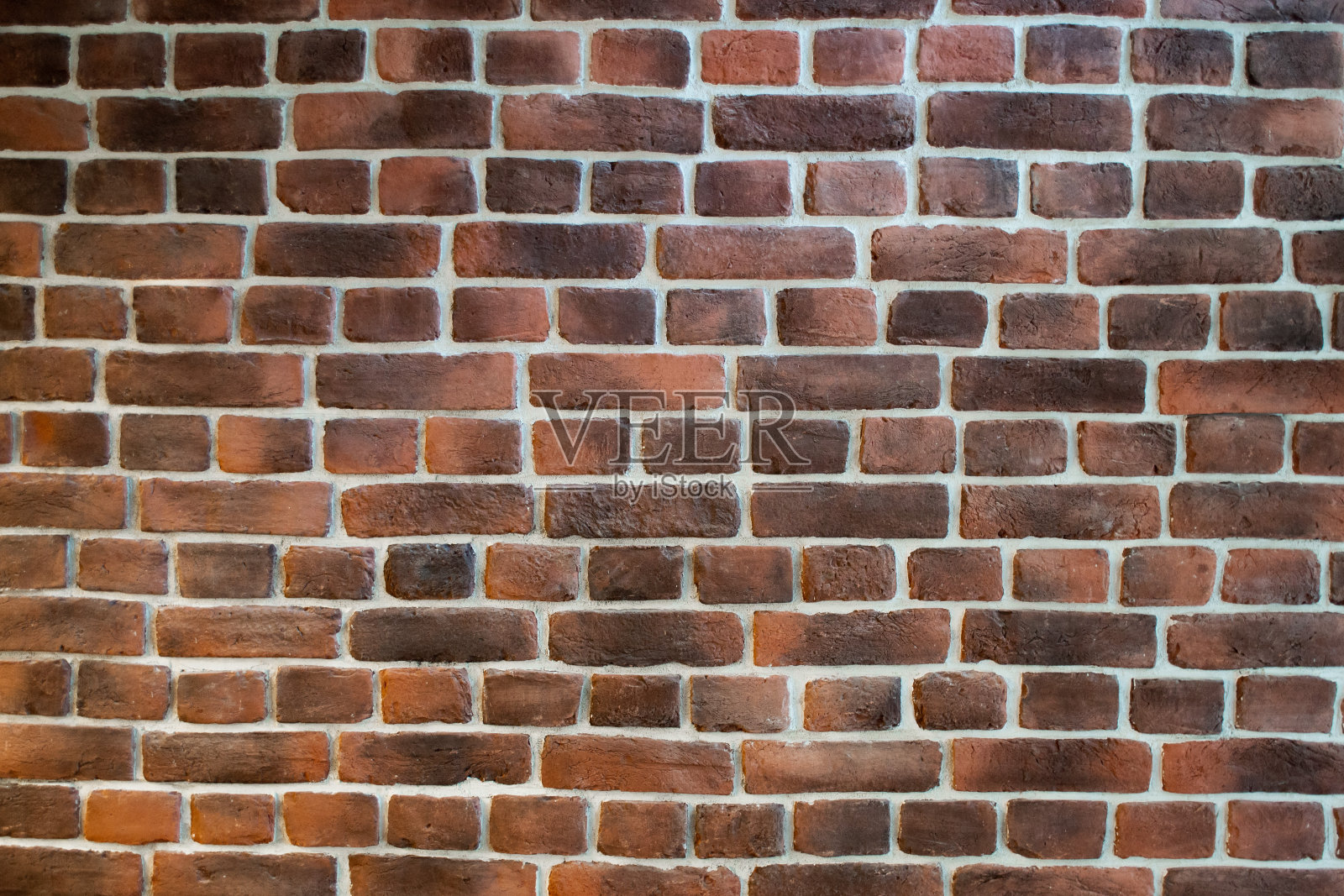新的赤陶土,深棕色的砖墙,白色的接缝作为背景照片摄影图片