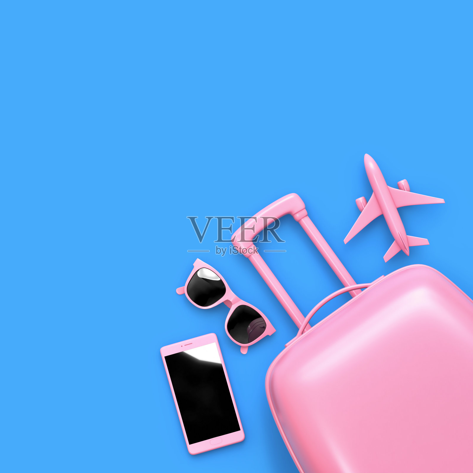 平躺着的粉色行李箱、太阳镜、智能手机和玩具飞机被蓝色隔离照片摄影图片