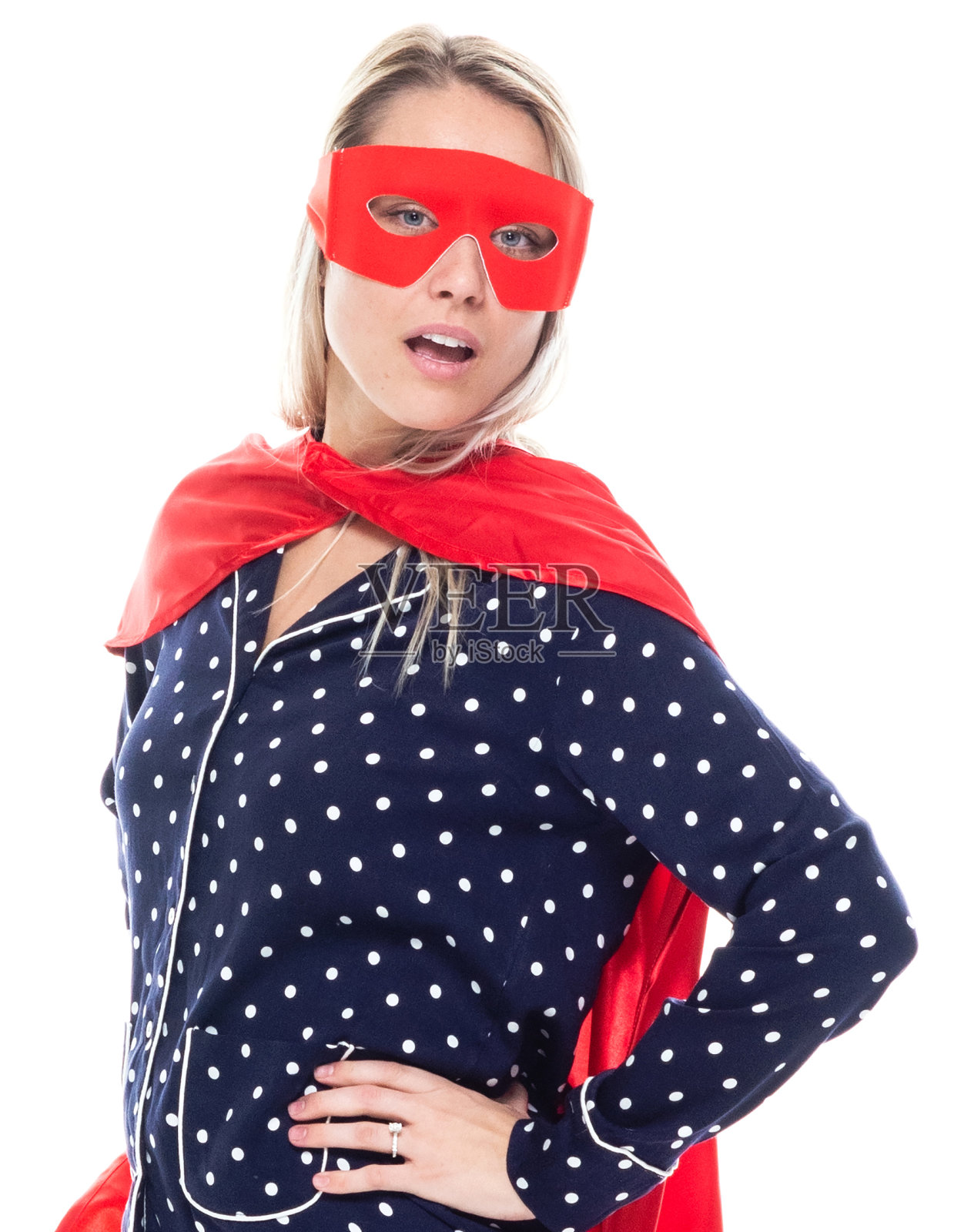 年轻的白人女超人穿着斗篷站在白色背景前照片摄影图片