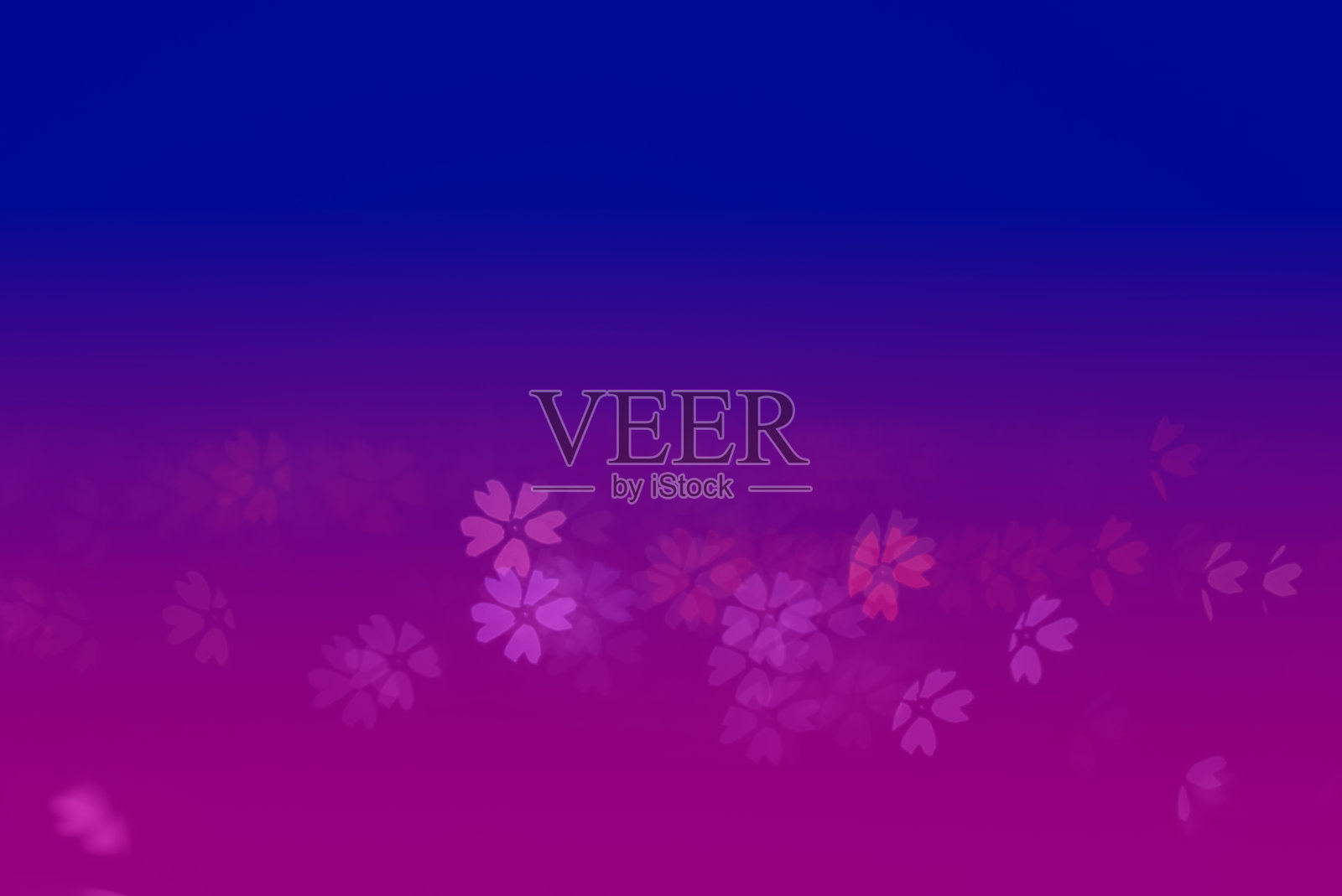 一个别致的树叶形状的散景,背景是蓝色和紫色的渐变。照片摄影图片