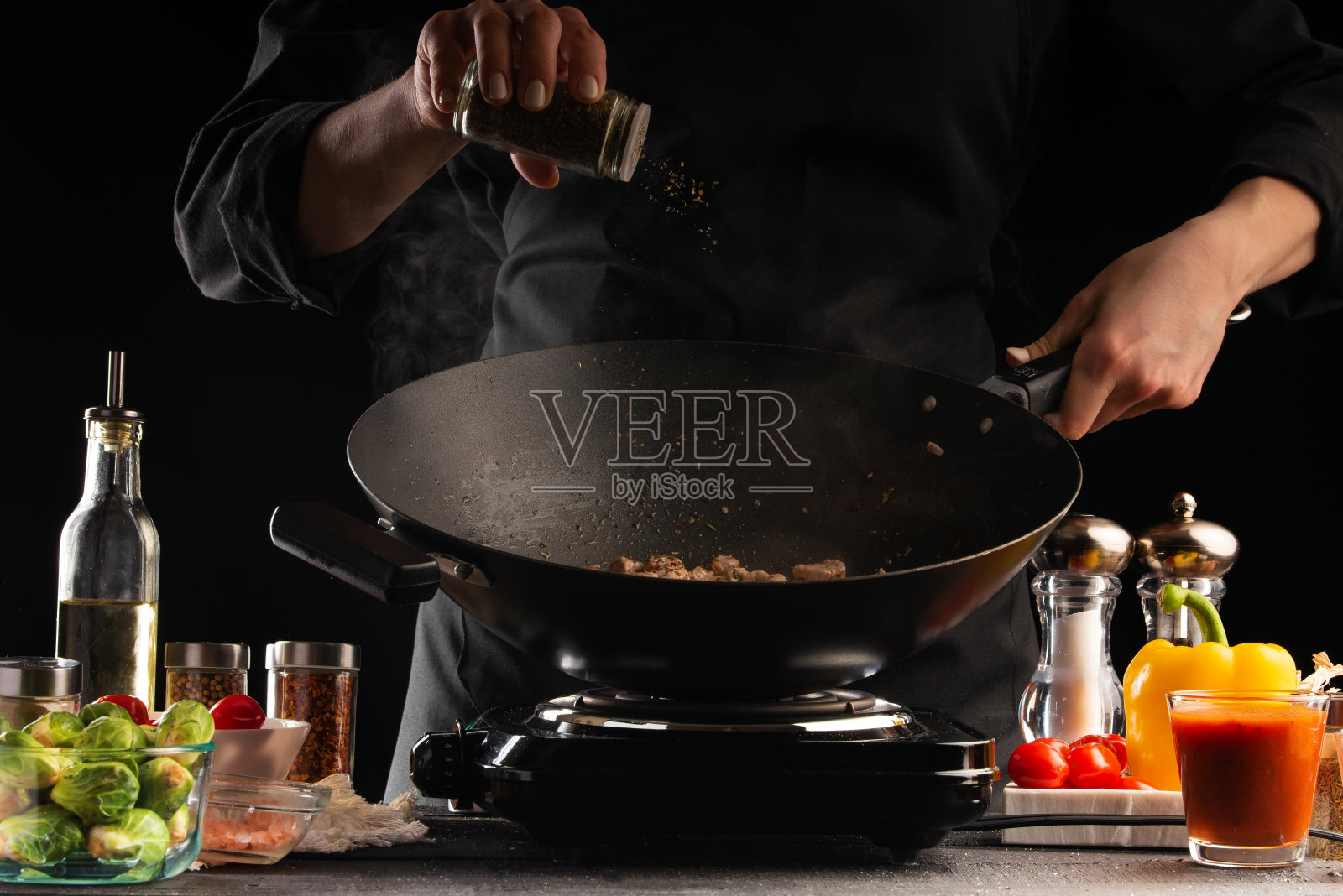 厨师撒调味料,定格动作,准备肉类菜肴,以蔬菜为背景,烹饪,餐饮业,食谱,餐饮和酒店业务照片摄影图片