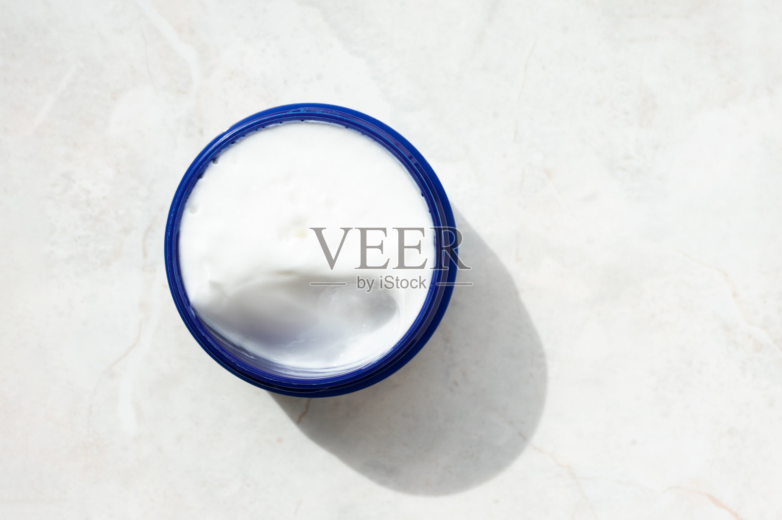 打开脸保湿在蓝色罐子大理石背景与复制空间。身体或面部护理,俯视图。美白精华照片摄影图片
