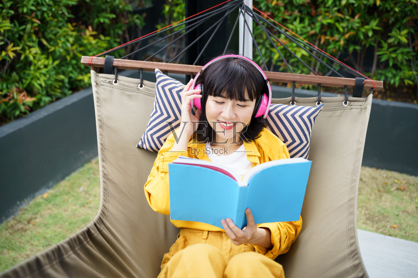 年轻女人在家放松地读书听音乐照片摄影图片