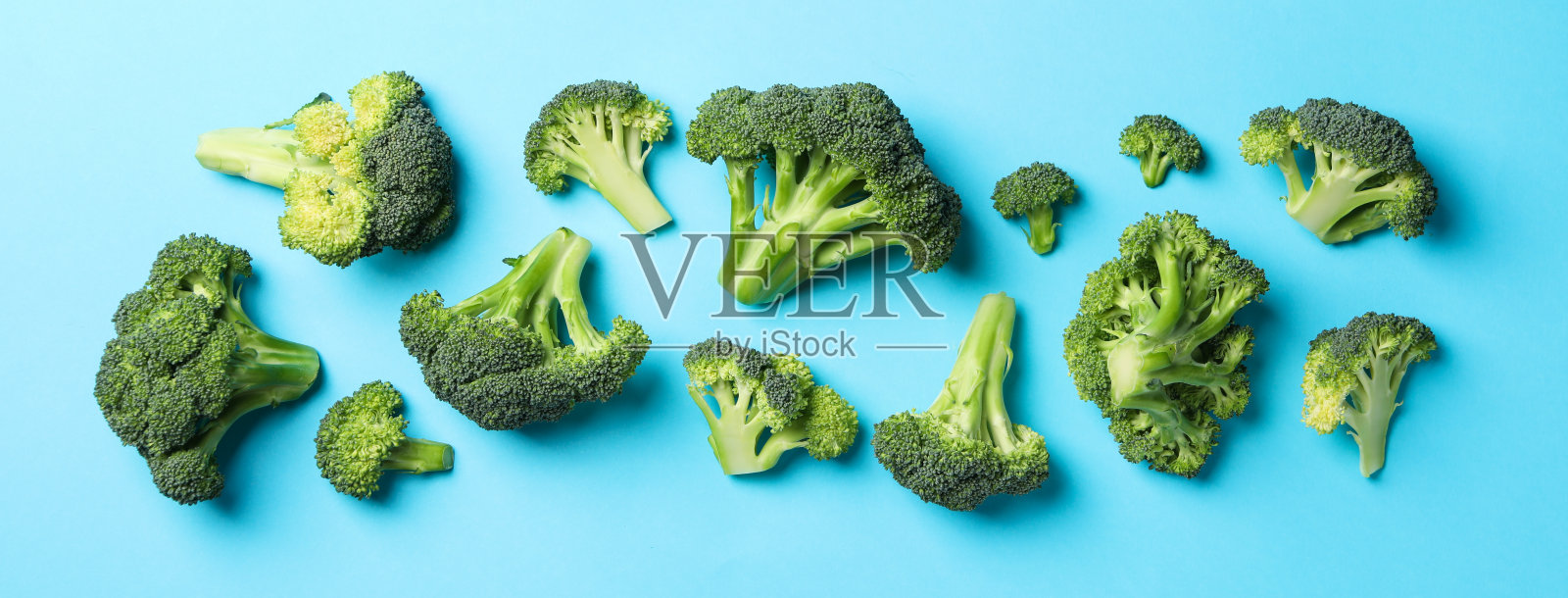 西兰花在蓝色背景,俯视图。健康的食物照片摄影图片