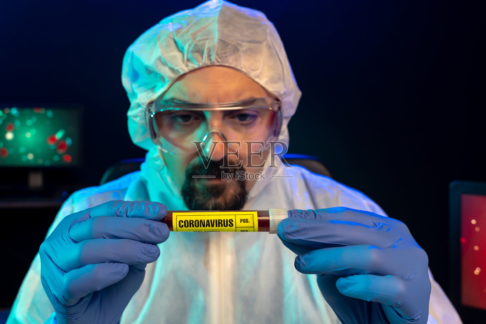 戴着蓝色外科手套和防护眼镜的实验室科学家在实验室观察冠状病毒血样照片摄影图片