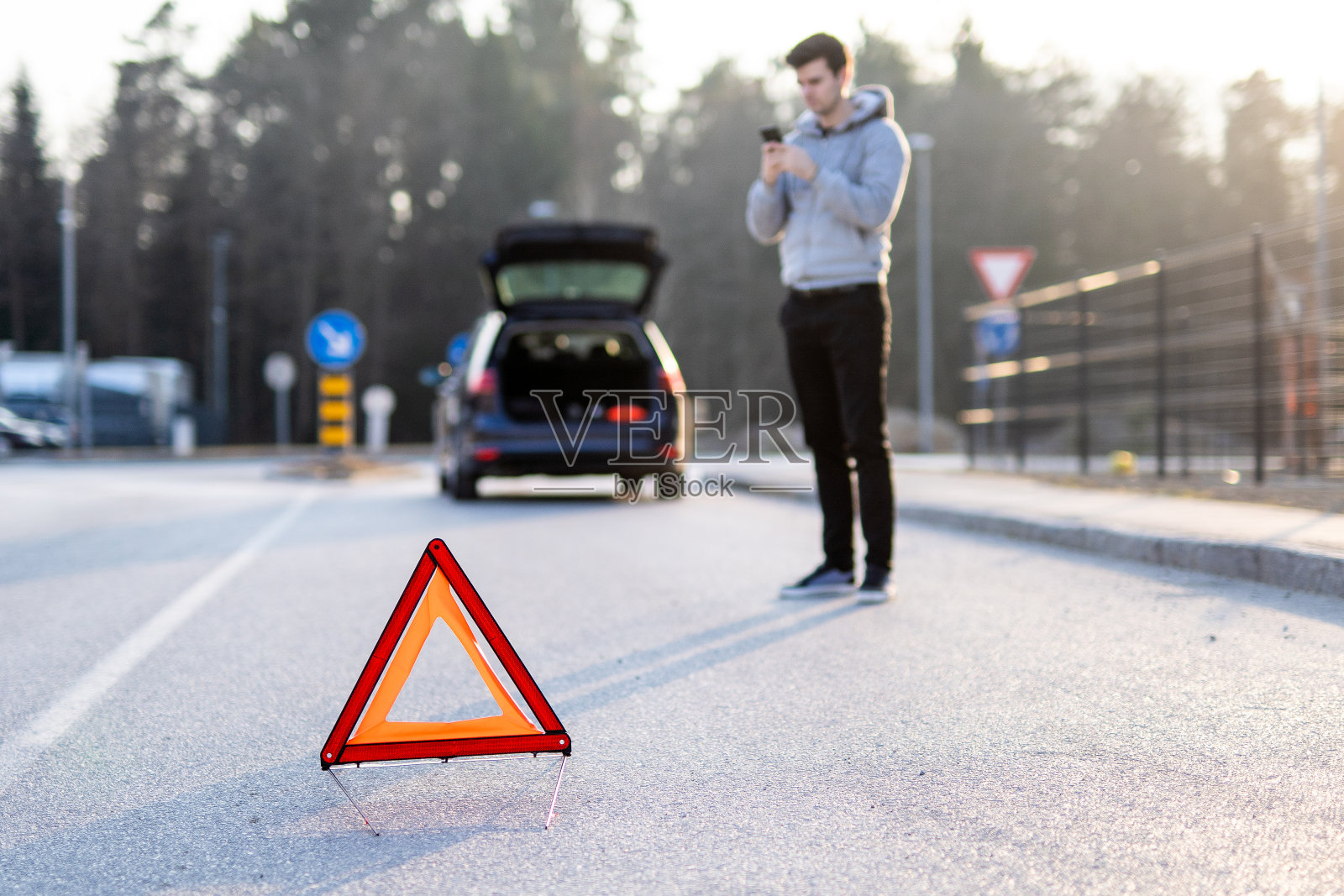 白种人正在放下可折叠的三角形警告牌照片摄影图片