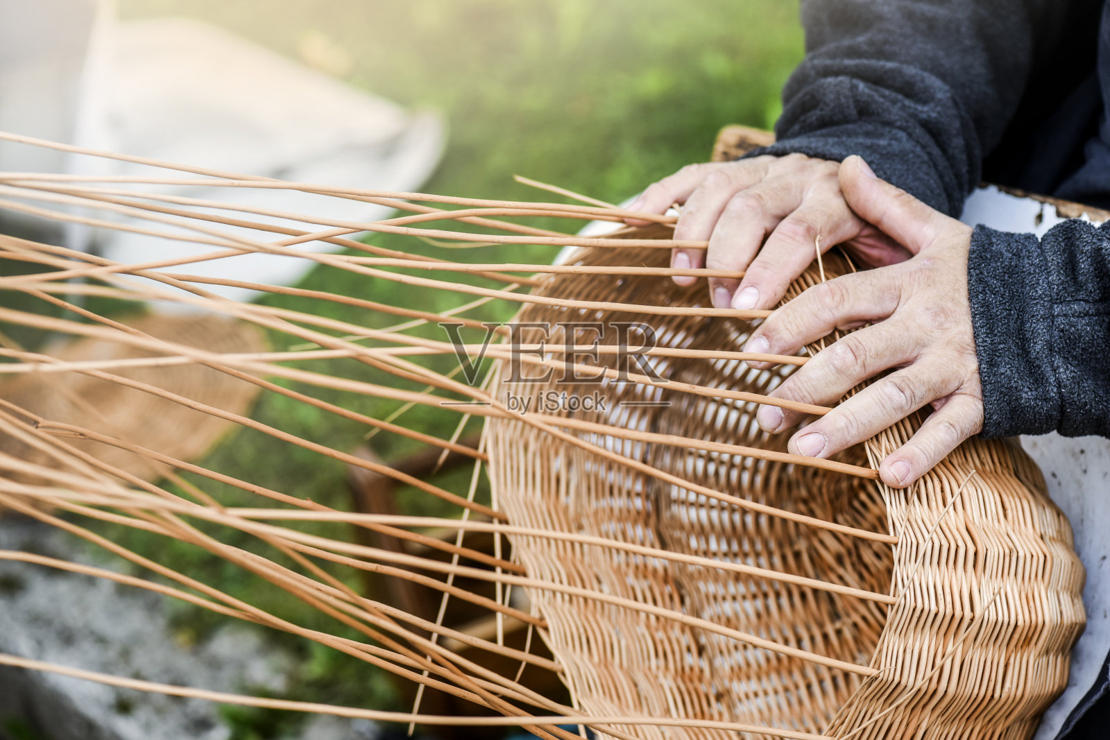 男子的手正在制作或制作柳条篮子照片摄影图片