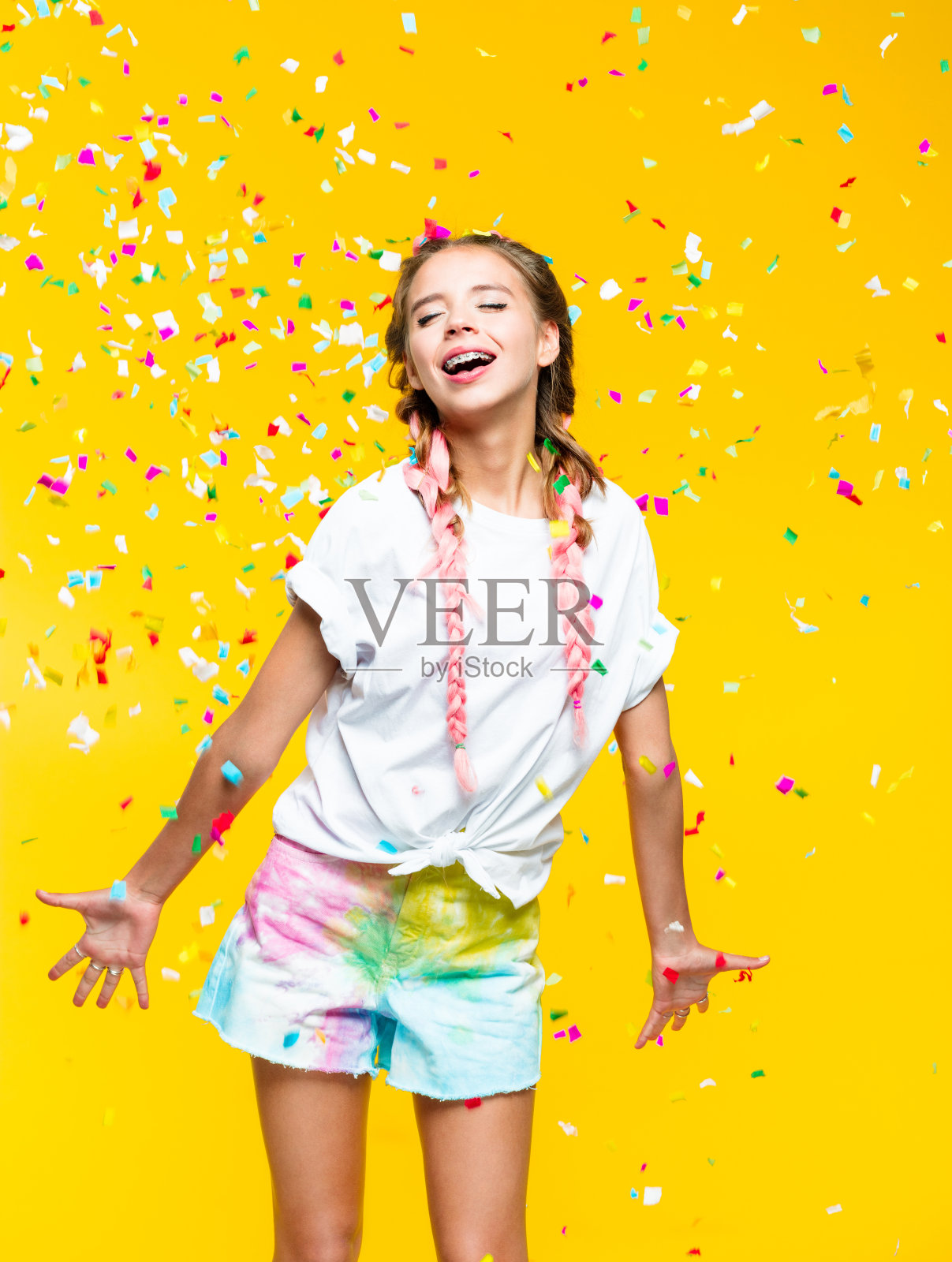 夏日少女站在五彩缤纷的五彩纸屑中照片摄影图片