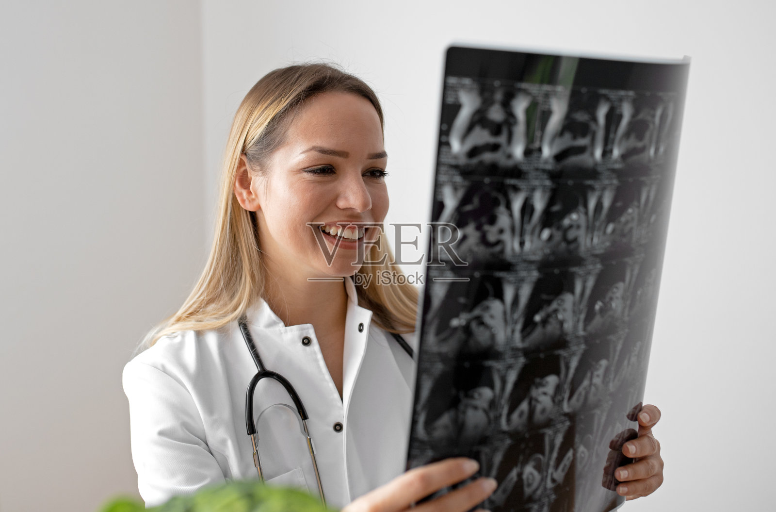 年轻女医生在她的办公室里看着x光照片照片摄影图片