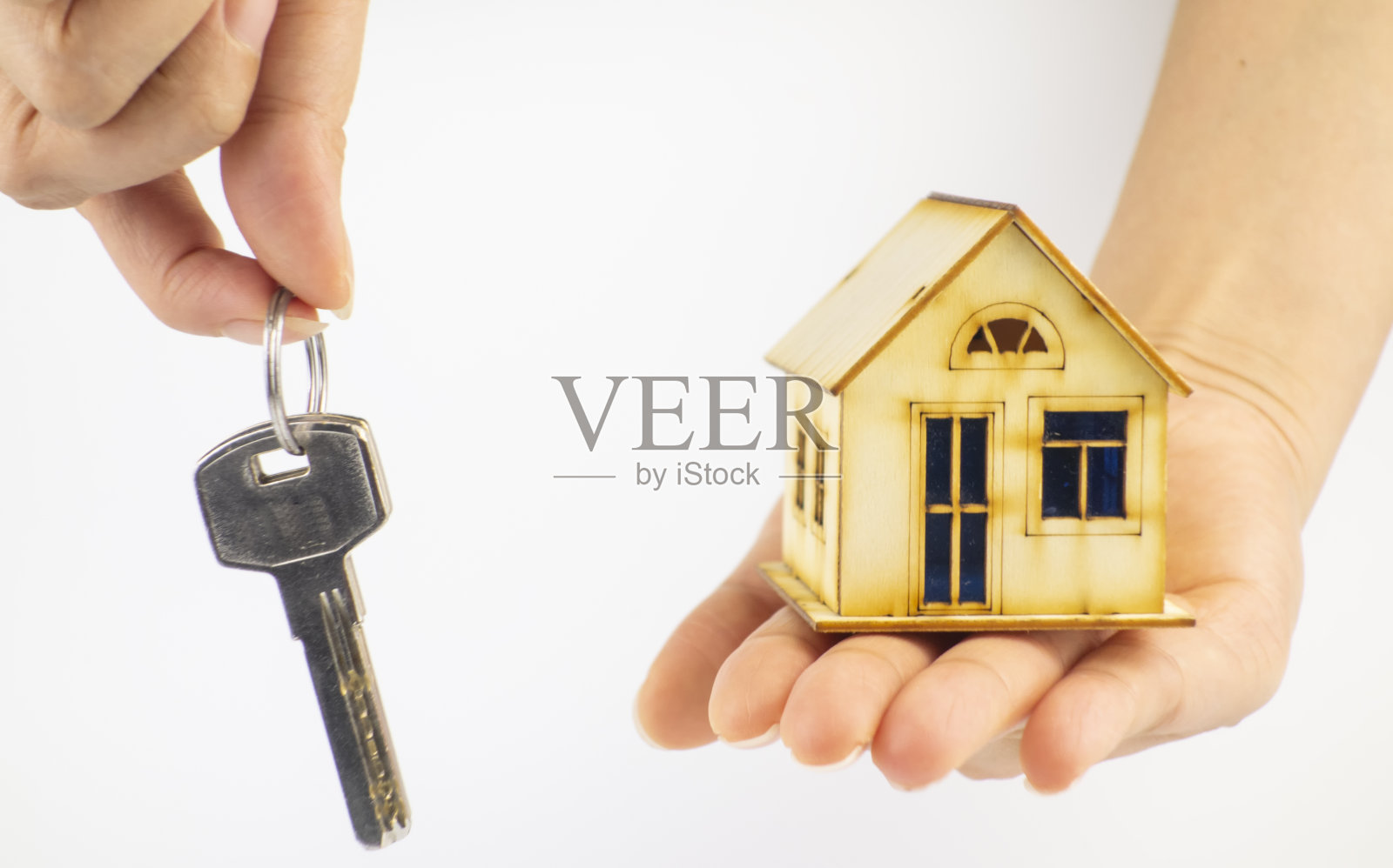手里拿着钥匙和小房子照片摄影图片