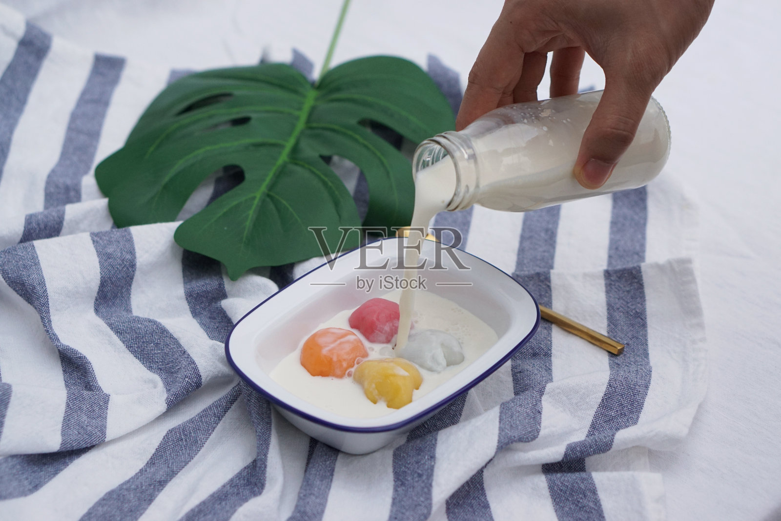 冰镇鲜奶黑芝麻汤圆(糯米团)。照片摄影图片