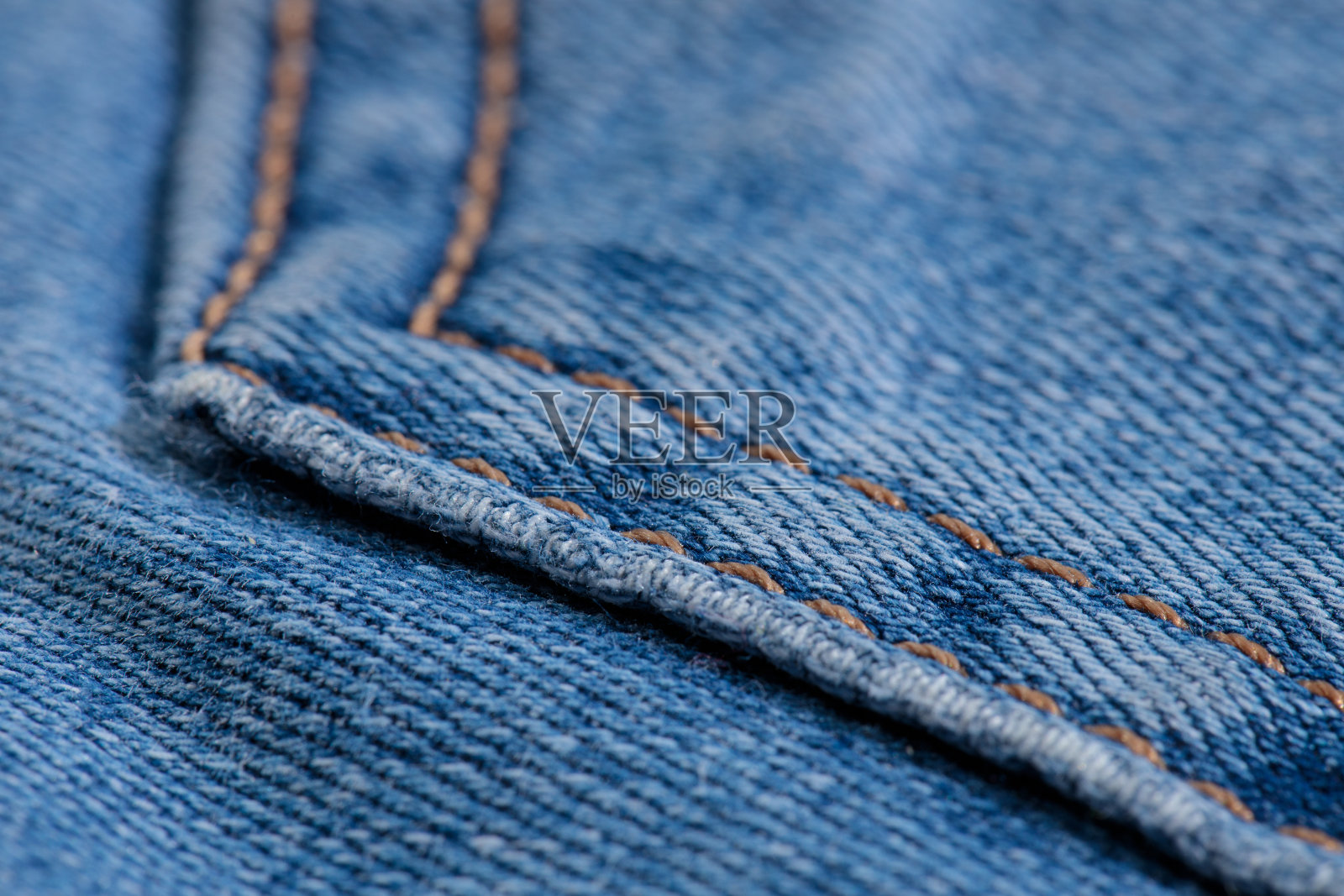 牛仔裤口袋裤特写与橙色线照片摄影图片