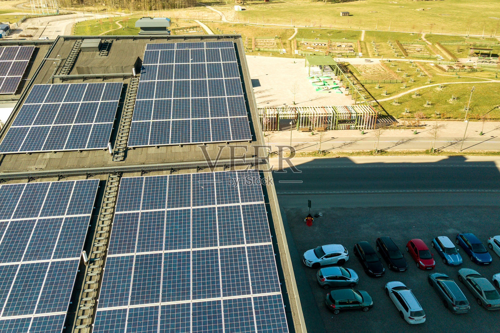 住宅大厦屋顶上的太阳能光伏板鸟瞰图,用于生产清洁电能。自治区住房的概念。照片摄影图片