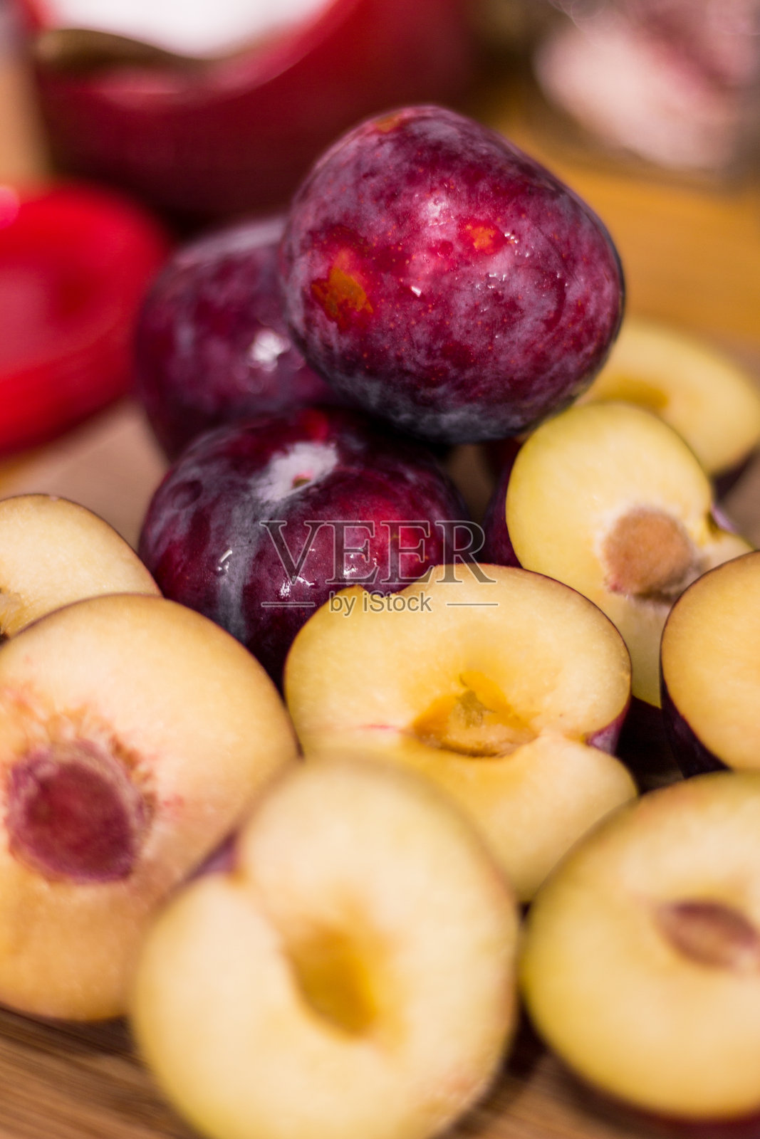 鲜梅子,在木片表面切成薄片照片摄影图片